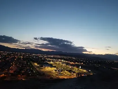 An aerial view of a city at night with mountains in the background.
