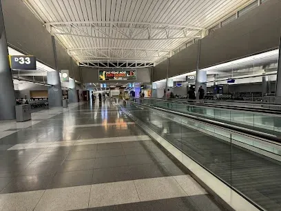 An empty airport terminal with a sign that says ' 33 ' on it.