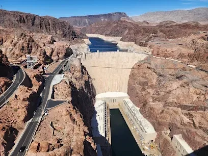 An aerial view of a large dam in the middle of a canyon.