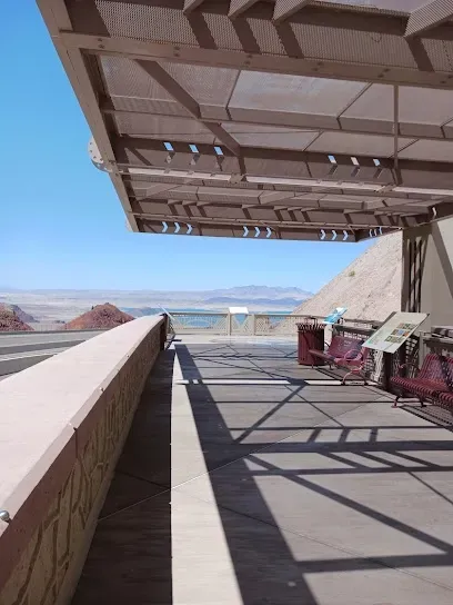 A balcony with a view of the ocean and mountains