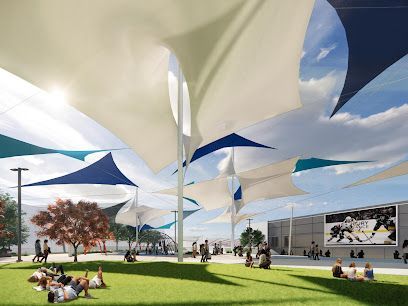 A group of people are sitting under umbrellas in a park.