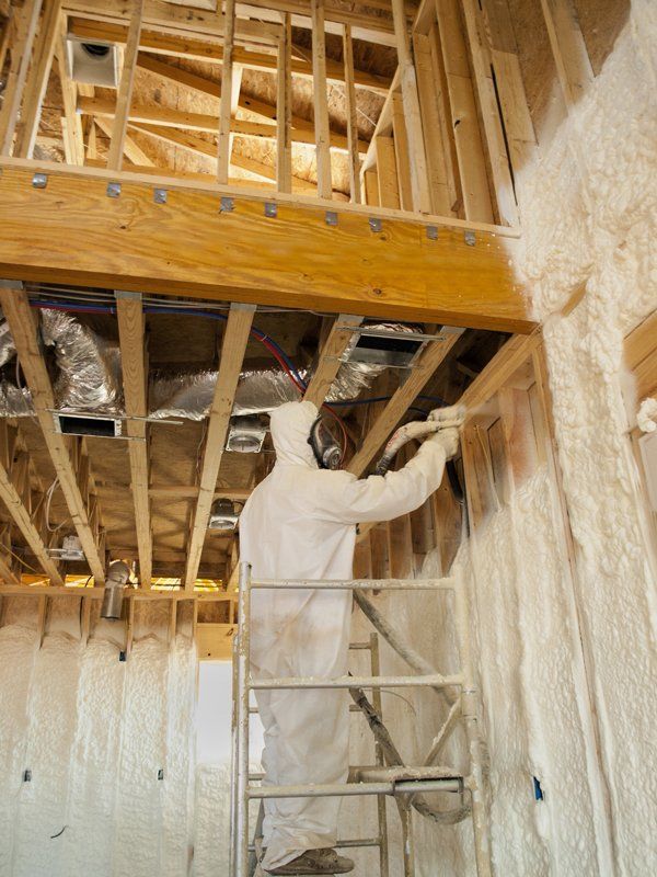 Icynene, Safe Foam Insulation — Spraying Insulation on Wooden Wall in Seguin, TX