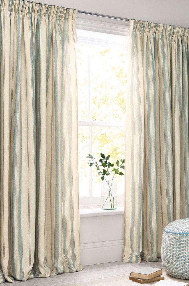 A Pair Of White Curtains Are Hanging On A Window In A Living Room — Caba's Drapery In Coffs Harbour, NSW