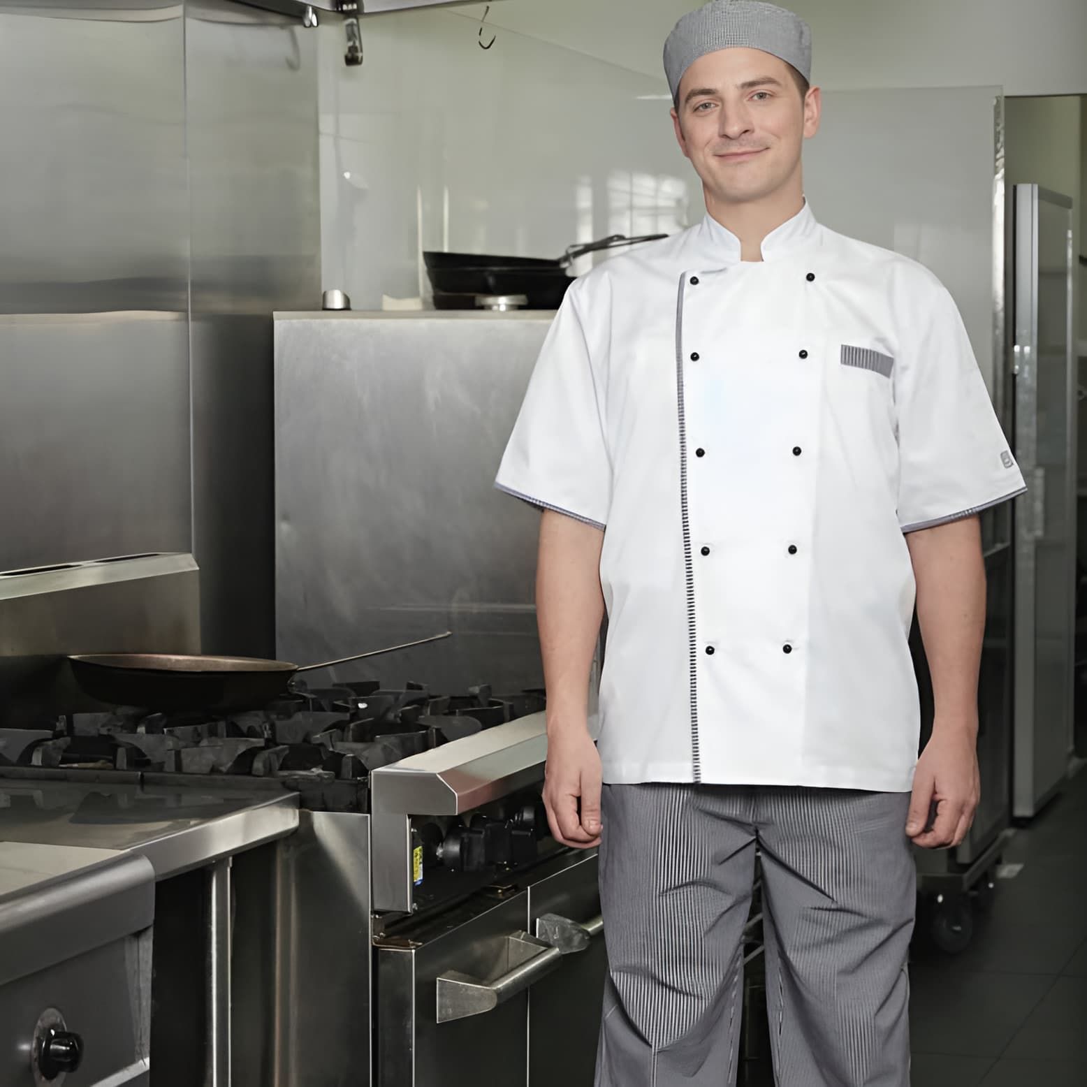 A Man In A Chef 's Uniform Is Standing In A Kitchen — Caba's Drapery In Coffs Harbour, NSW