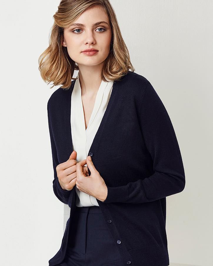 A Woman Is Wearing A Blue Cardigan And A White Shirt — Caba's Drapery In Coffs Harbour, NSW