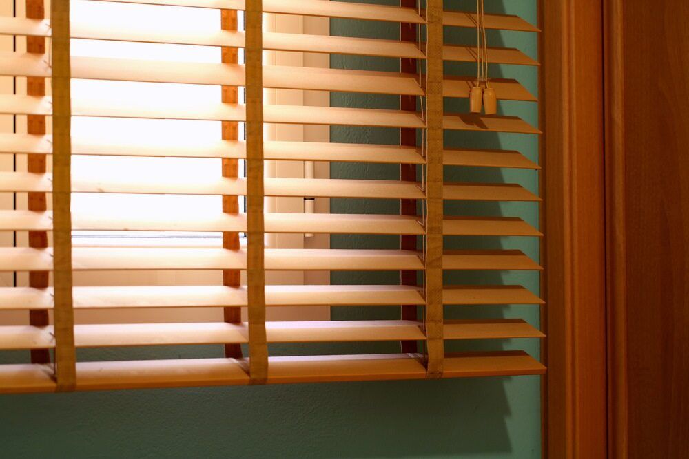 A Close Up Of A Window With Wooden Blinds On It — Caba's Drapery In Nambucca Heads, NSW