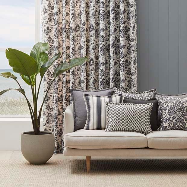A Living Room With A Couch, Pillows, And A Potted Plant — Caba's Drapery In Coffs Harbour, NSW
