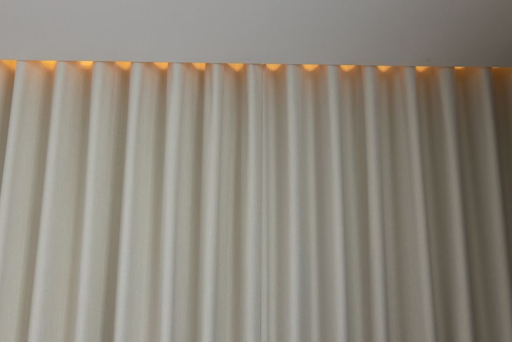 A Close Up Of A White Curtain With A Light Behind It — Caba's Drapery In Coffs Harbour, NSW