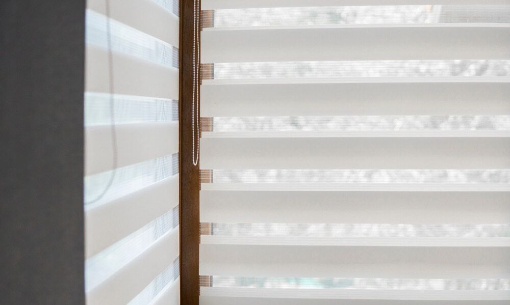 A Close Up Of A Window With Blinds On It — Caba's Drapery In Coffs Harbour, NSW