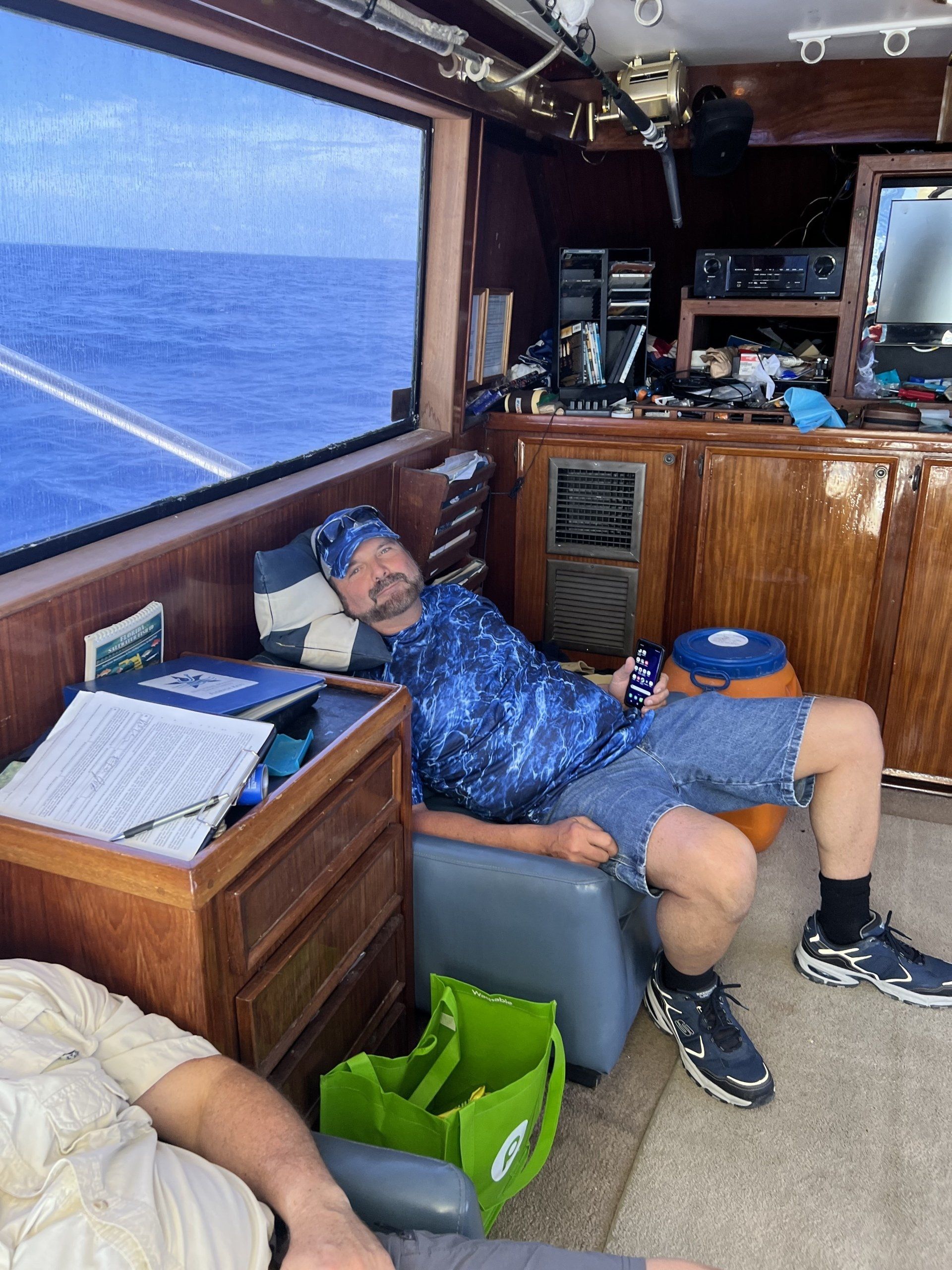 A man is sleeping in a chair on a boat