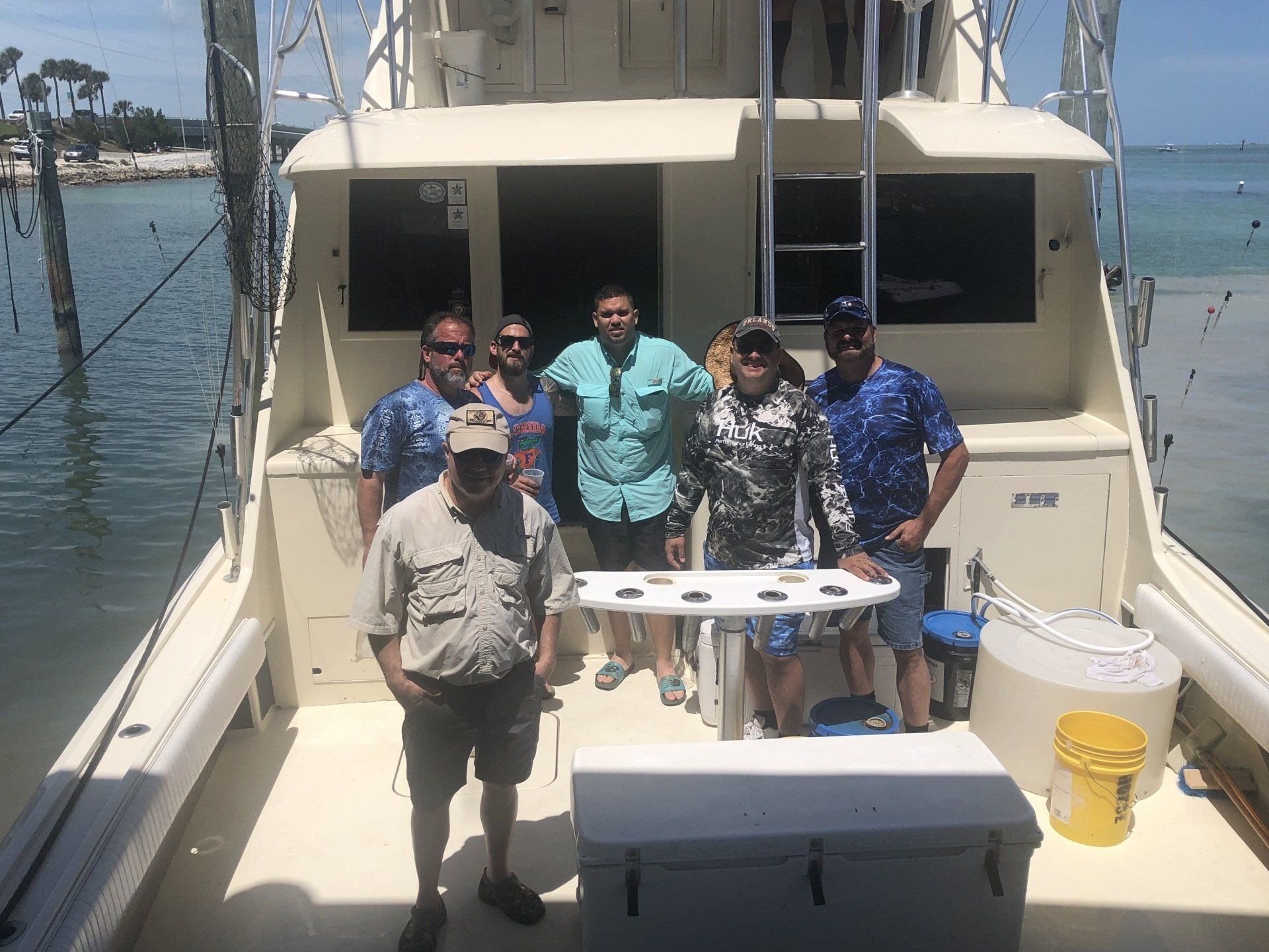 A group of people are standing on the deck of a boat.