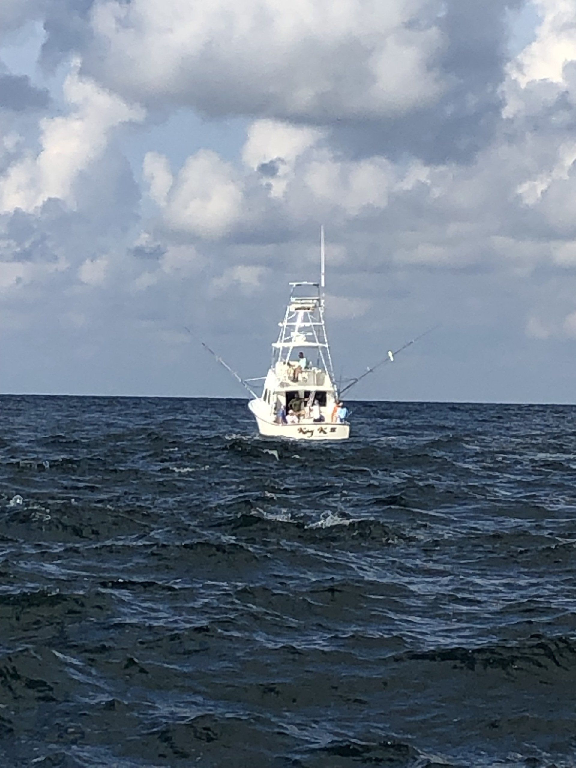 A boat is floating on top of a large body of water.