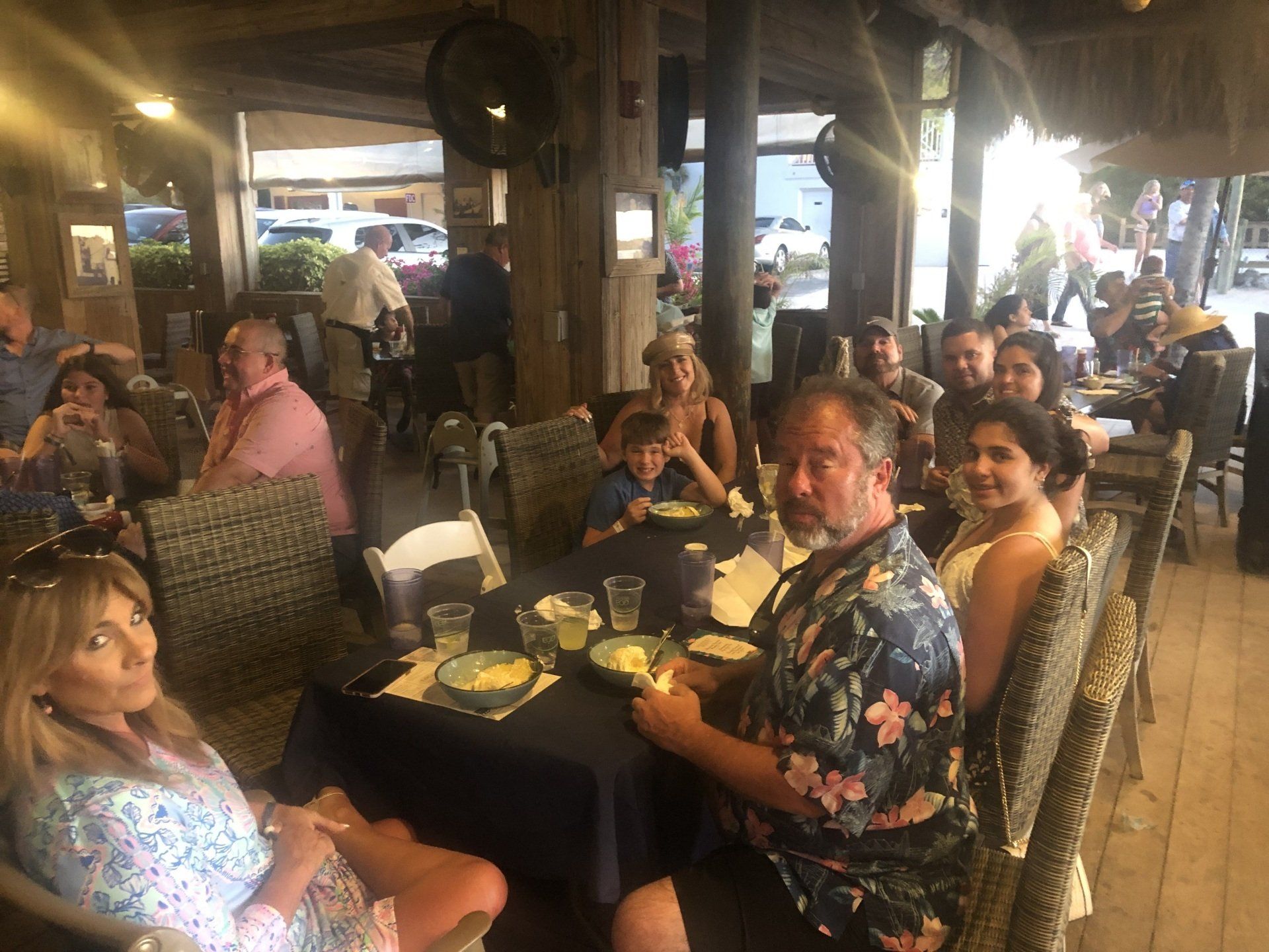 A group of people are sitting at tables in a restaurant.