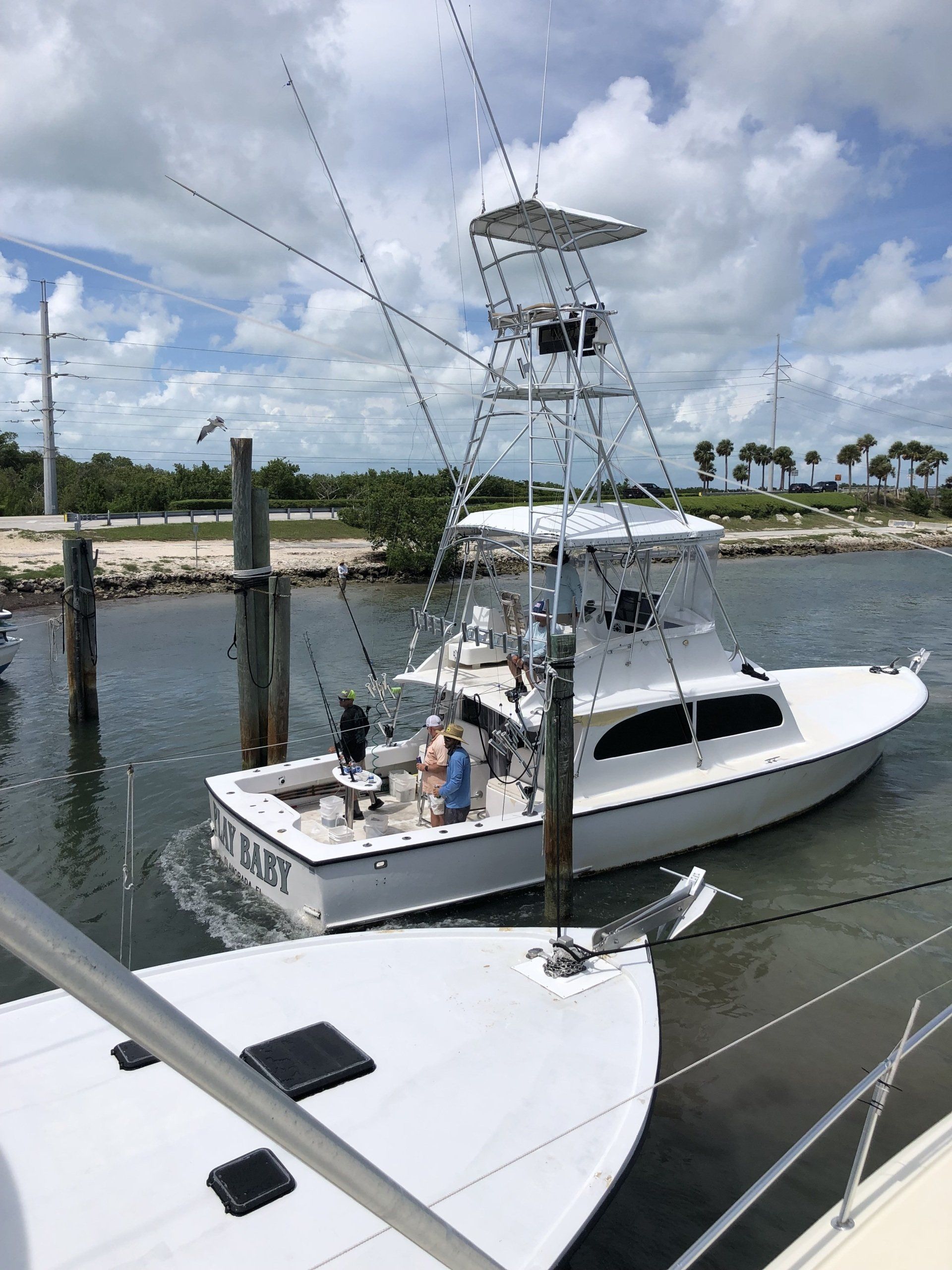 A large white boat is docked at a dock.