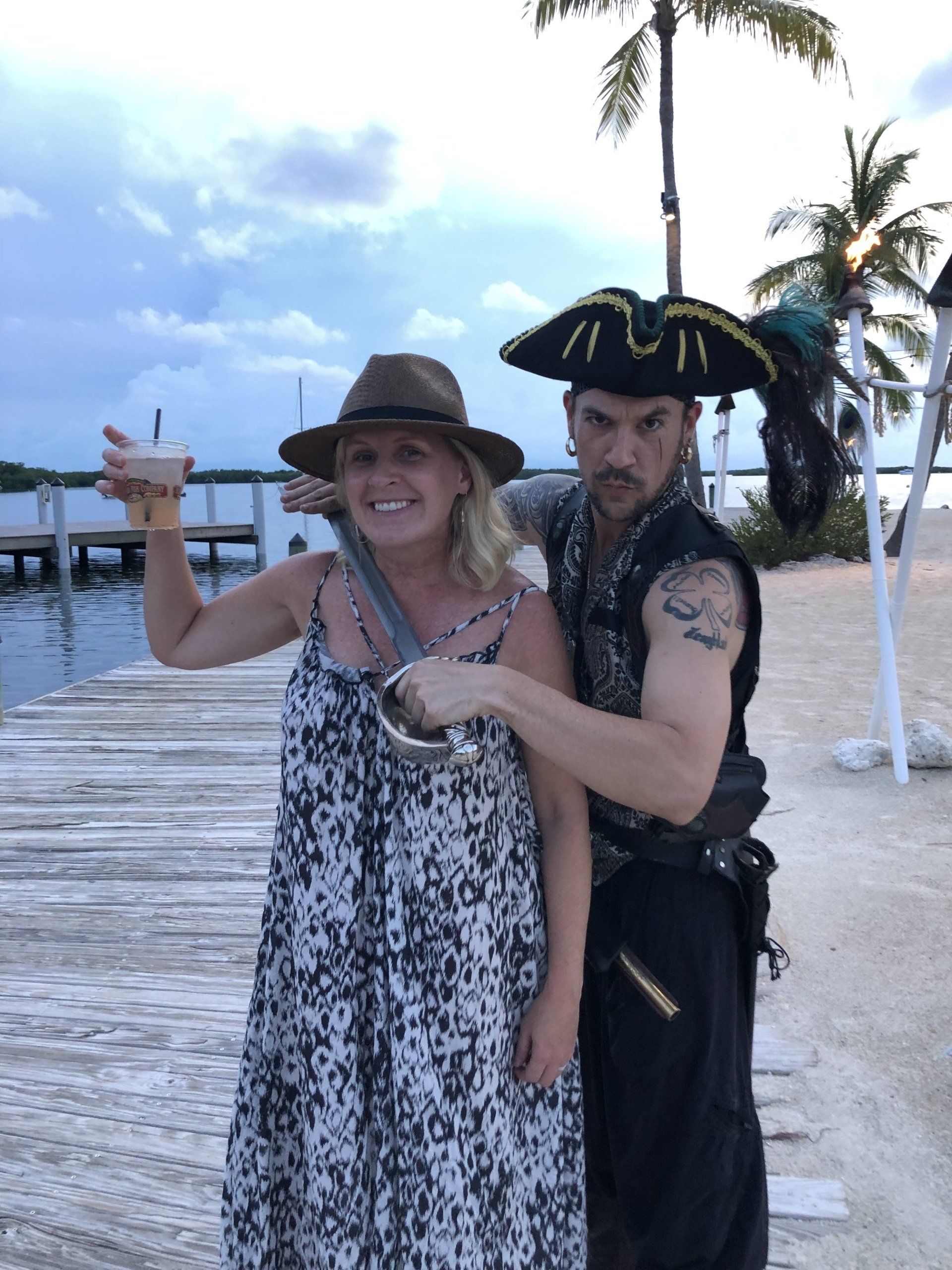 A man and a woman dressed as pirates on a beach
