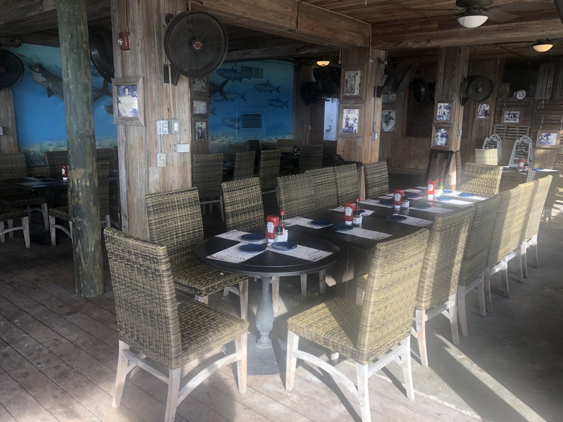 A long table with wicker chairs in a restaurant