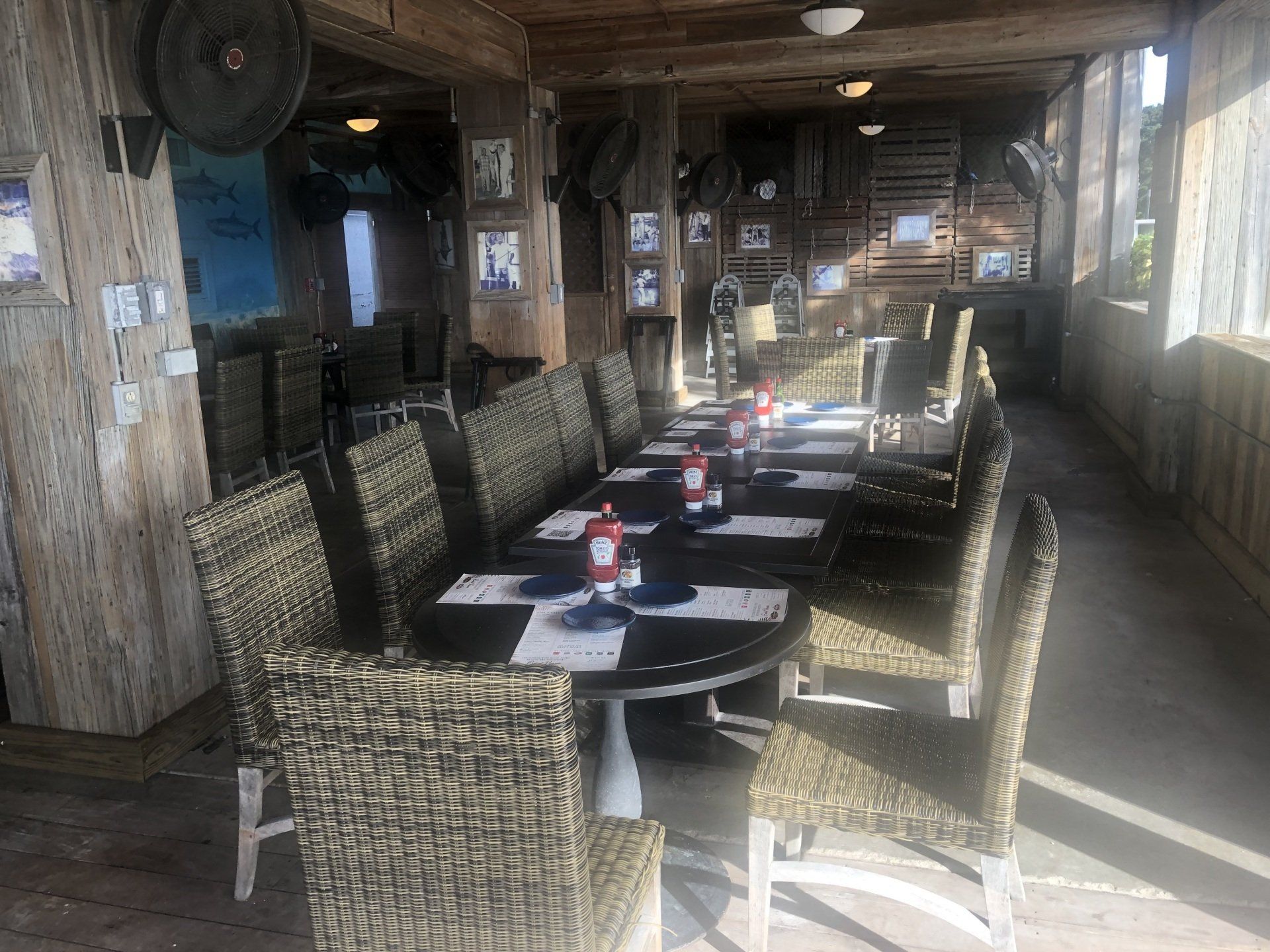 A long table with wicker chairs in a restaurant