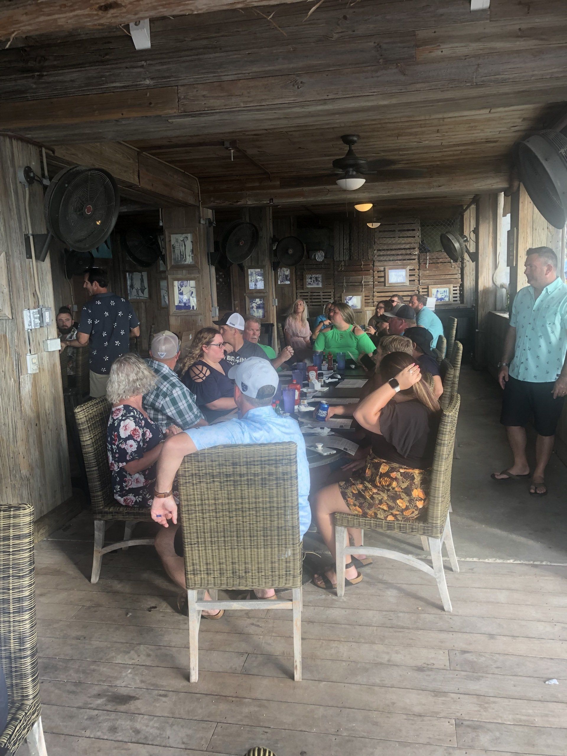 A group of people are sitting at tables in a restaurant.