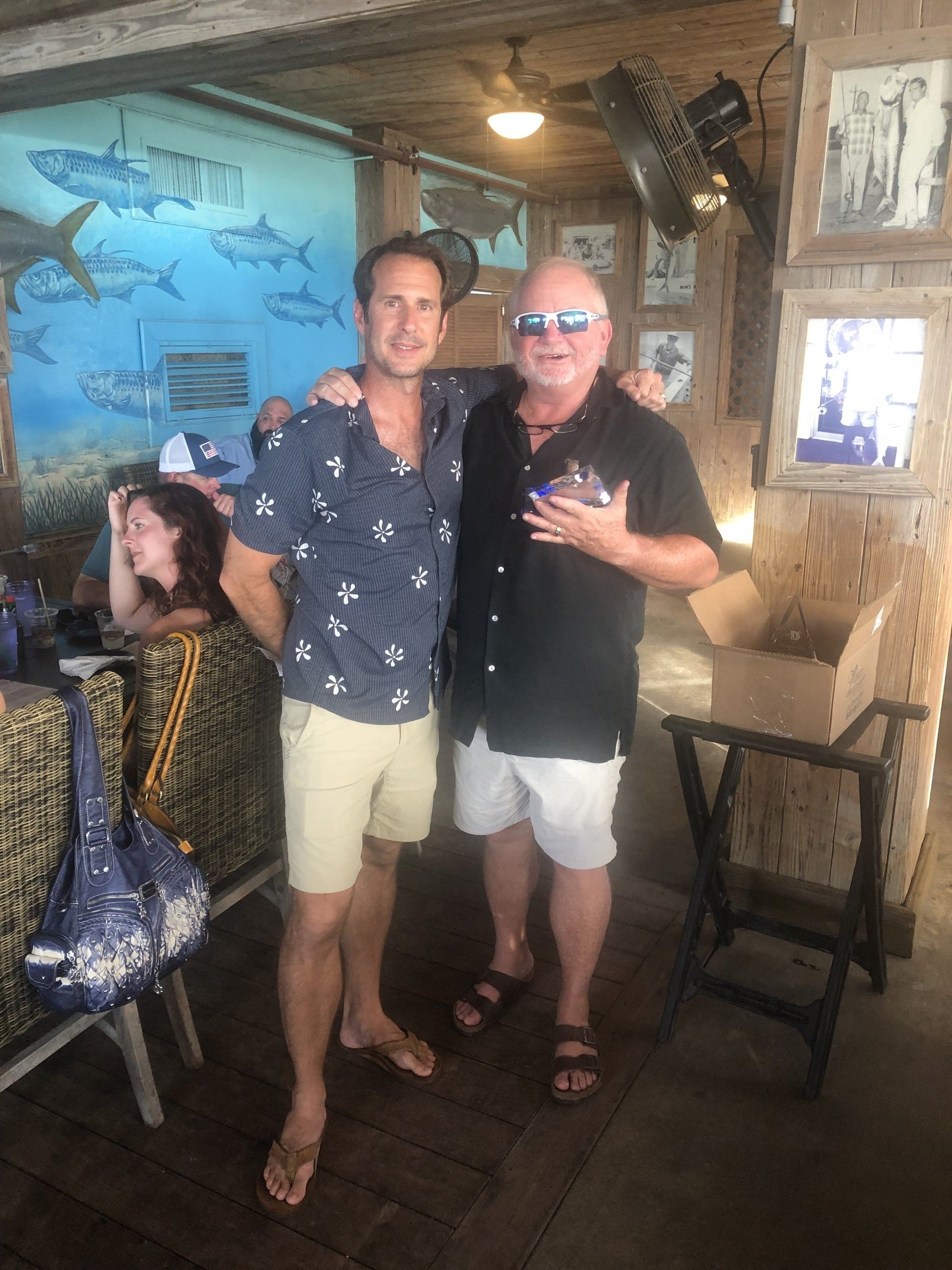 Two men are standing next to each other in a room.