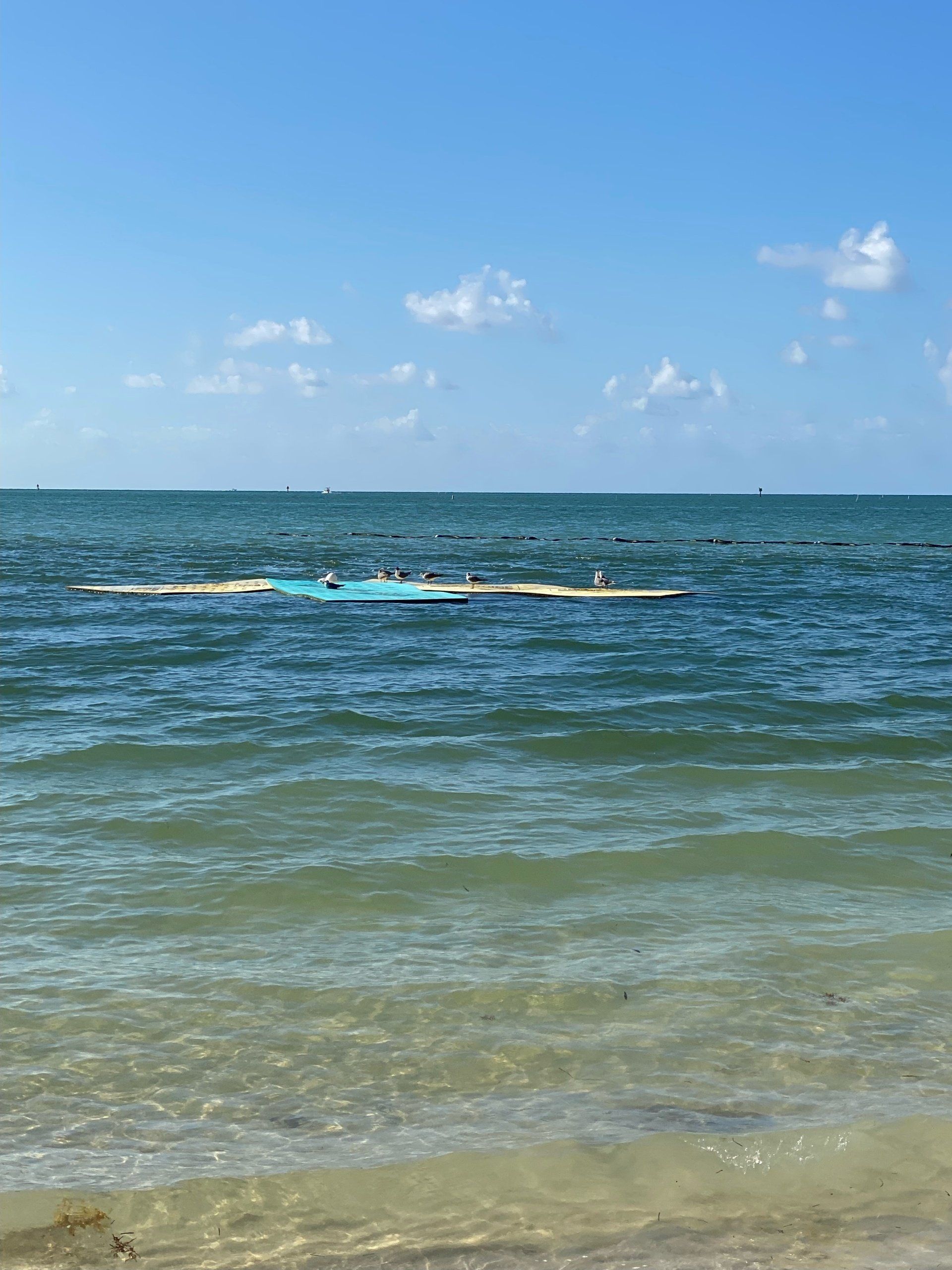A boat is floating on top of a body of water.