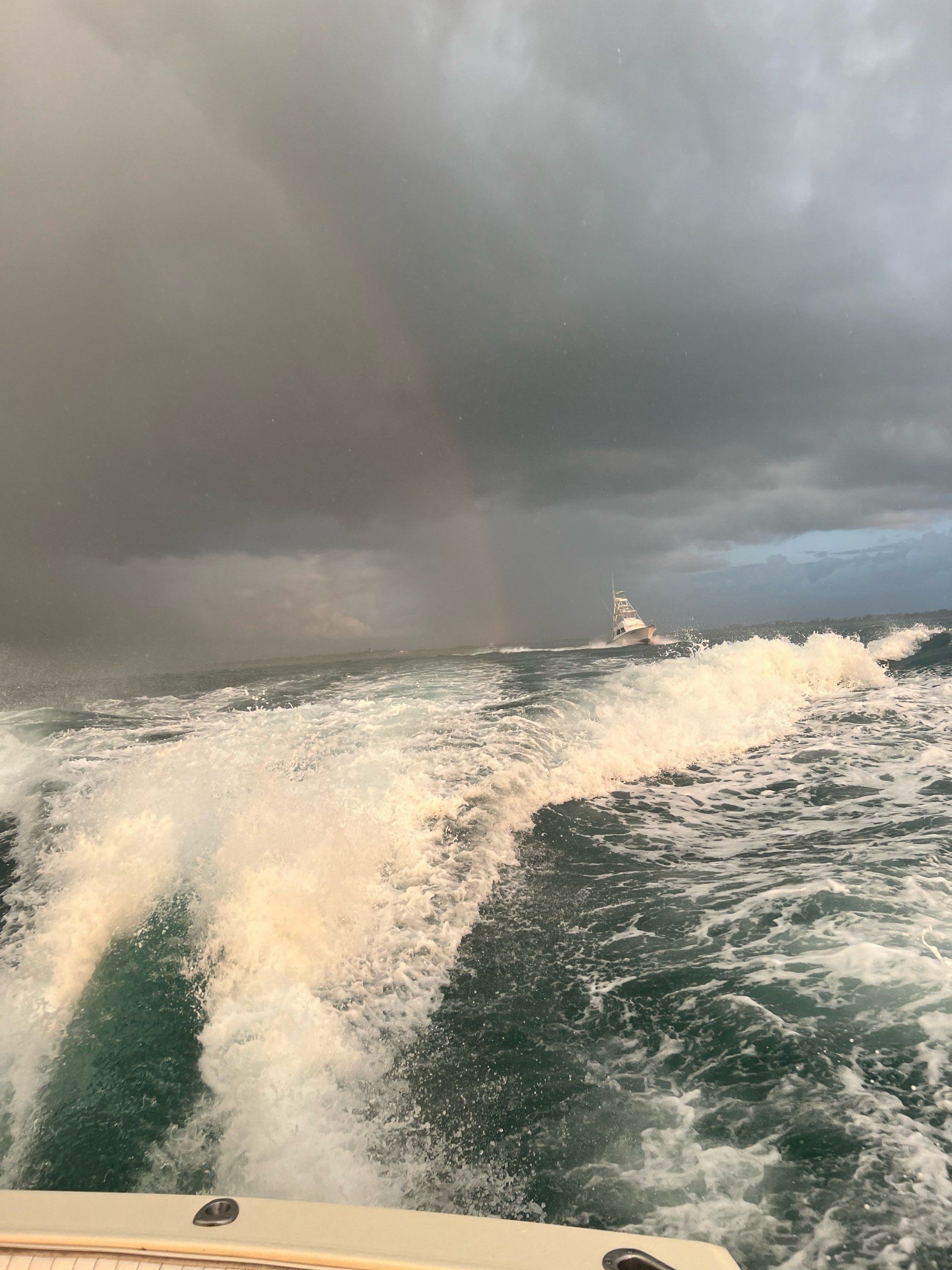 A boat is going through the ocean on a cloudy day