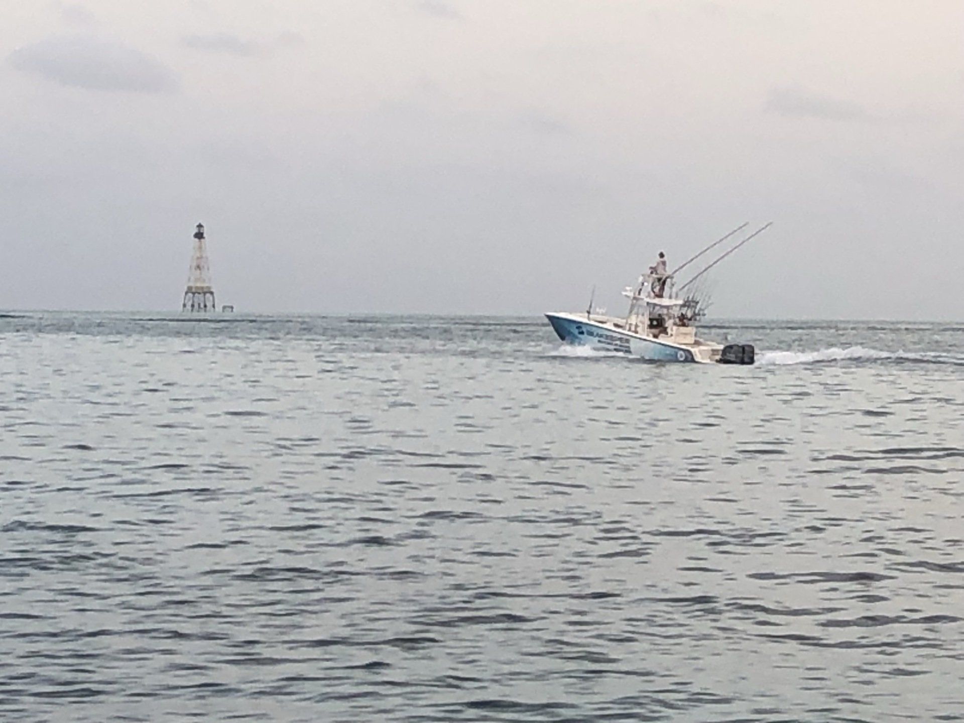 A boat is floating on top of a large body of water.