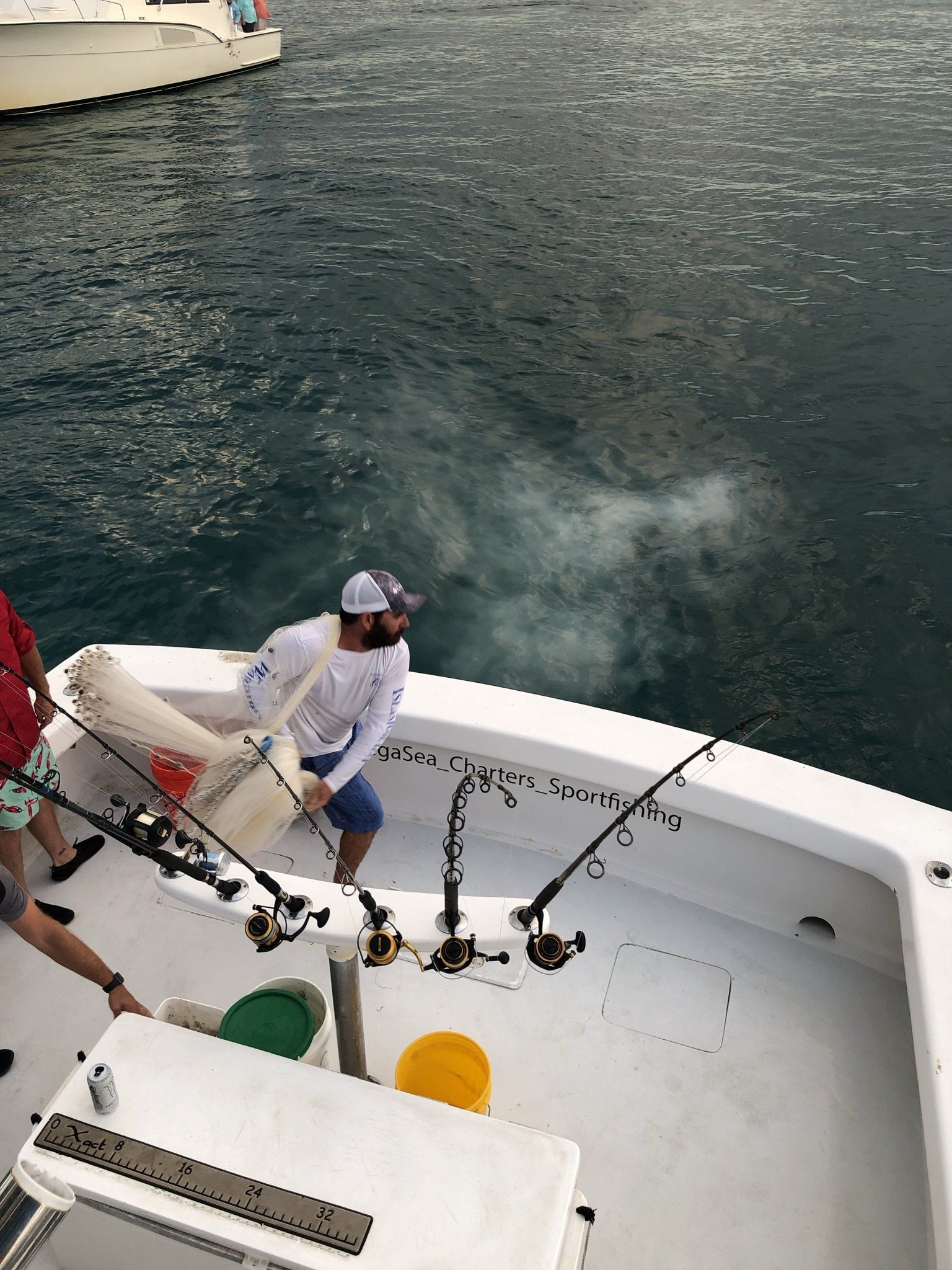 A group of people are fishing on a boat in the ocean.