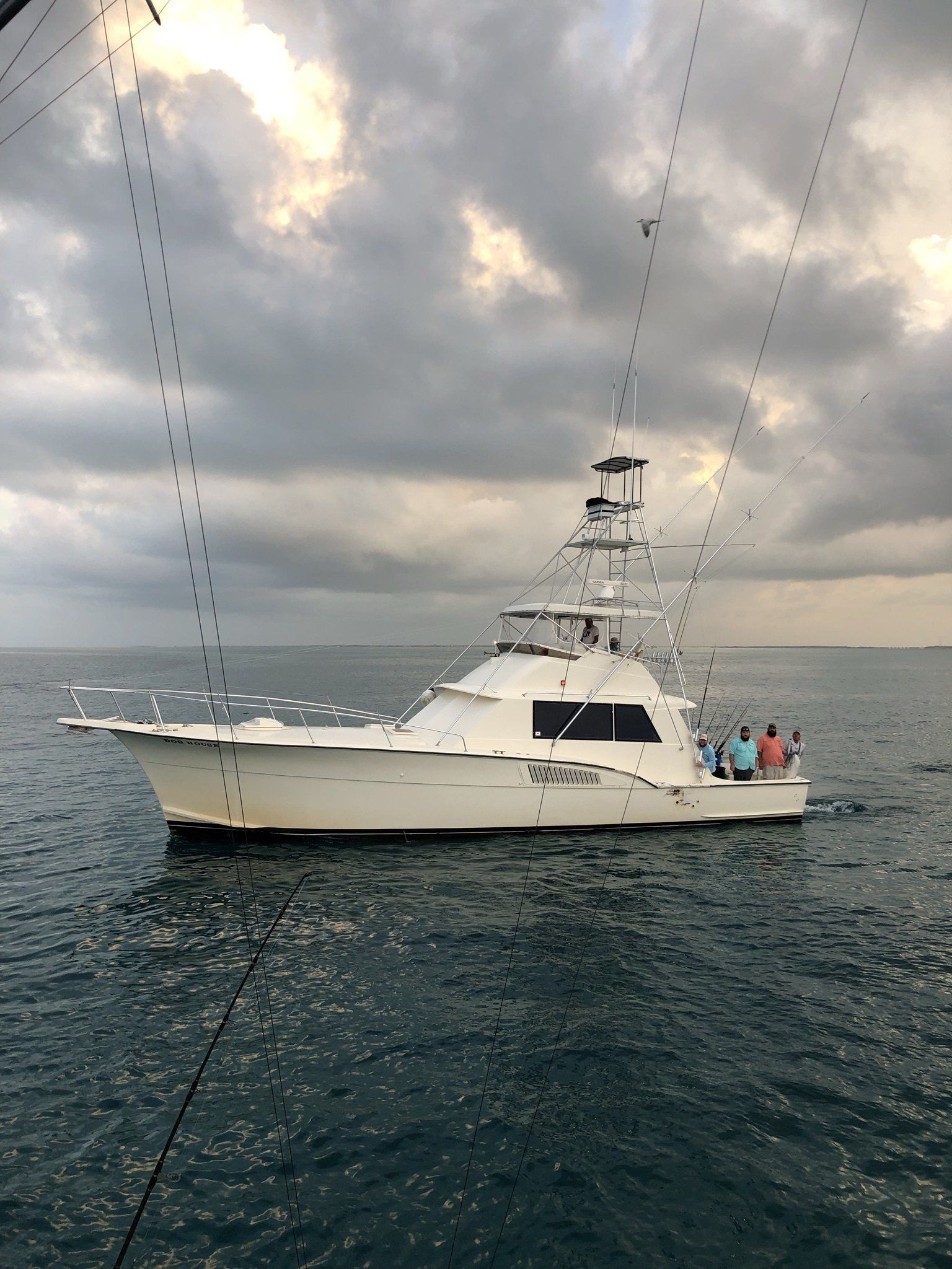 A large white boat is floating on top of a body of water