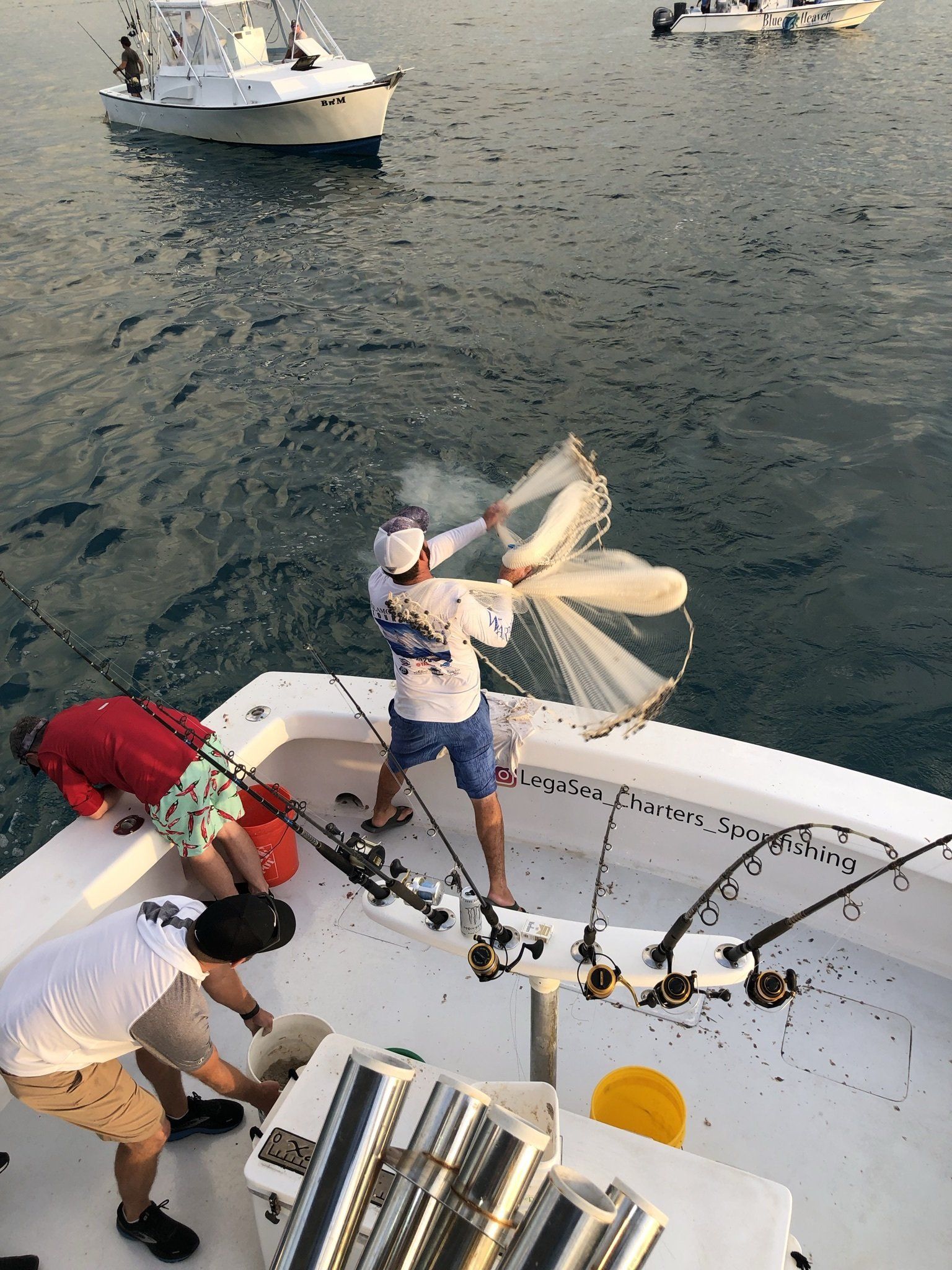 A group of men are fishing on a boat in the ocean