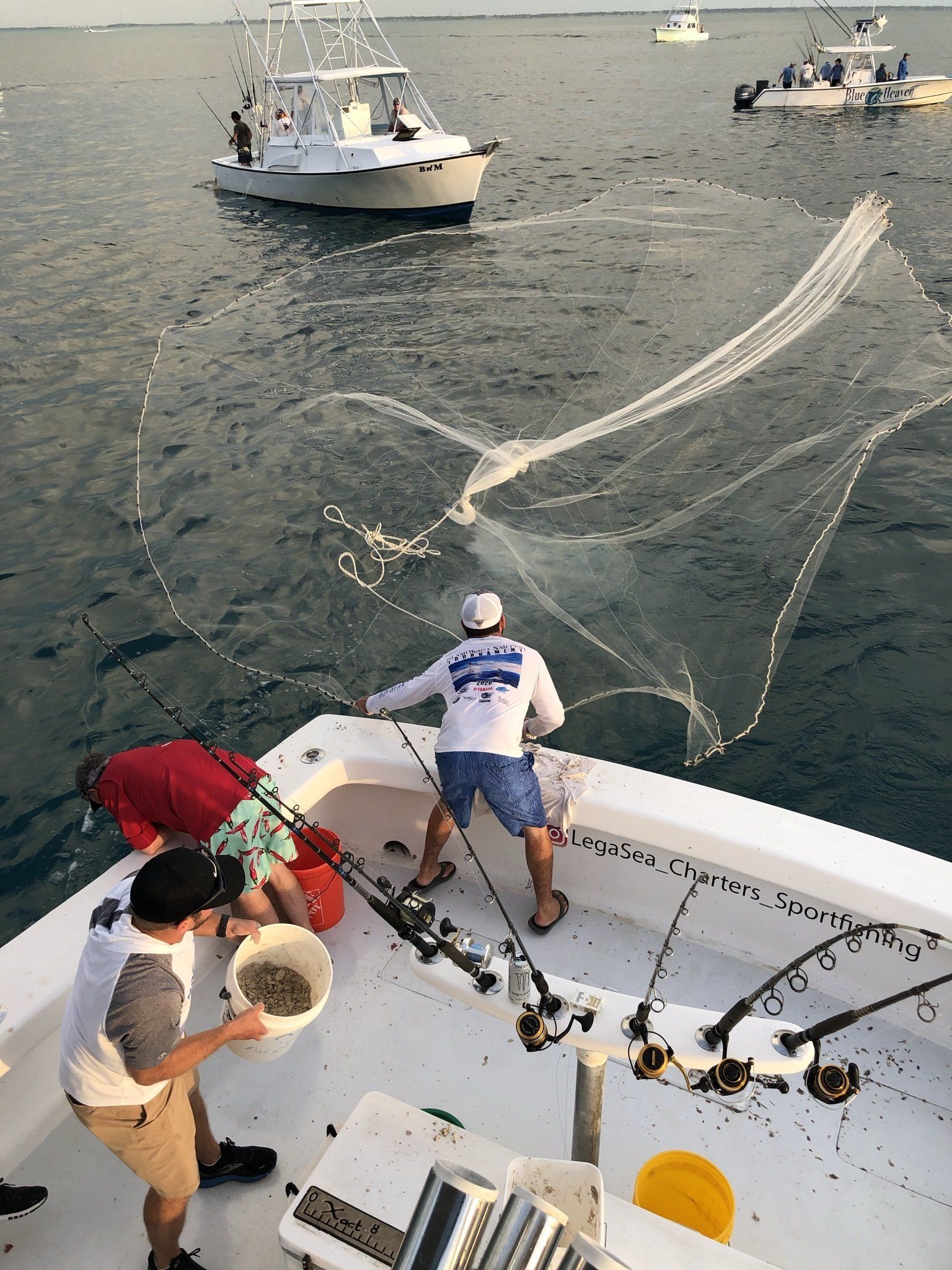 A group of men are fishing on a boat in the ocean.