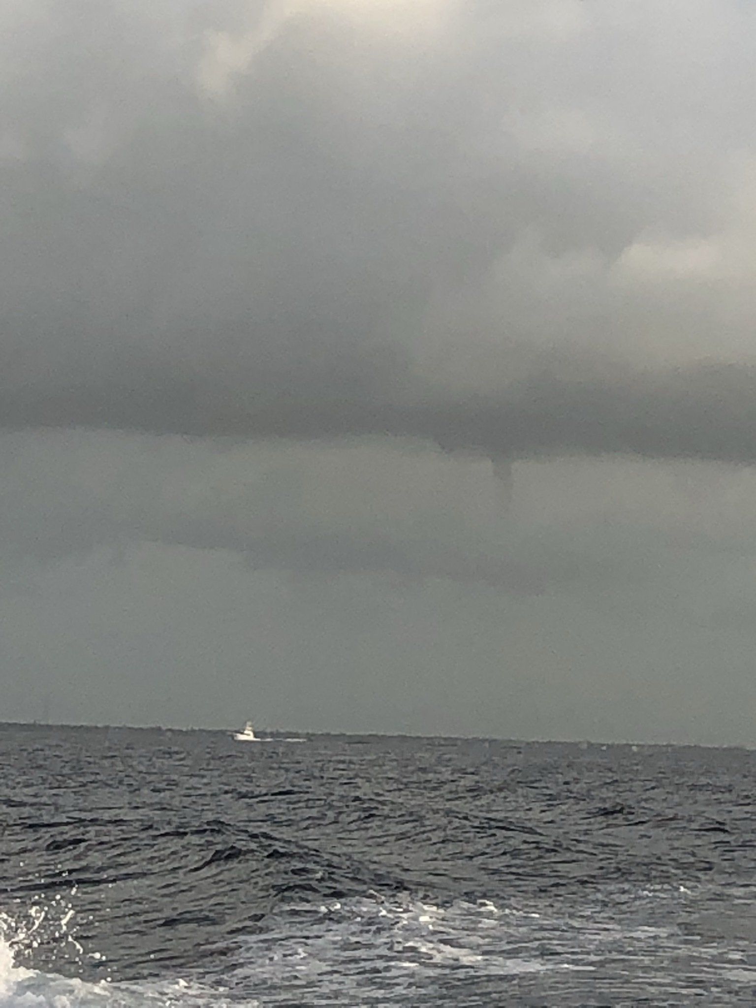 A boat is floating on top of a large body of water.