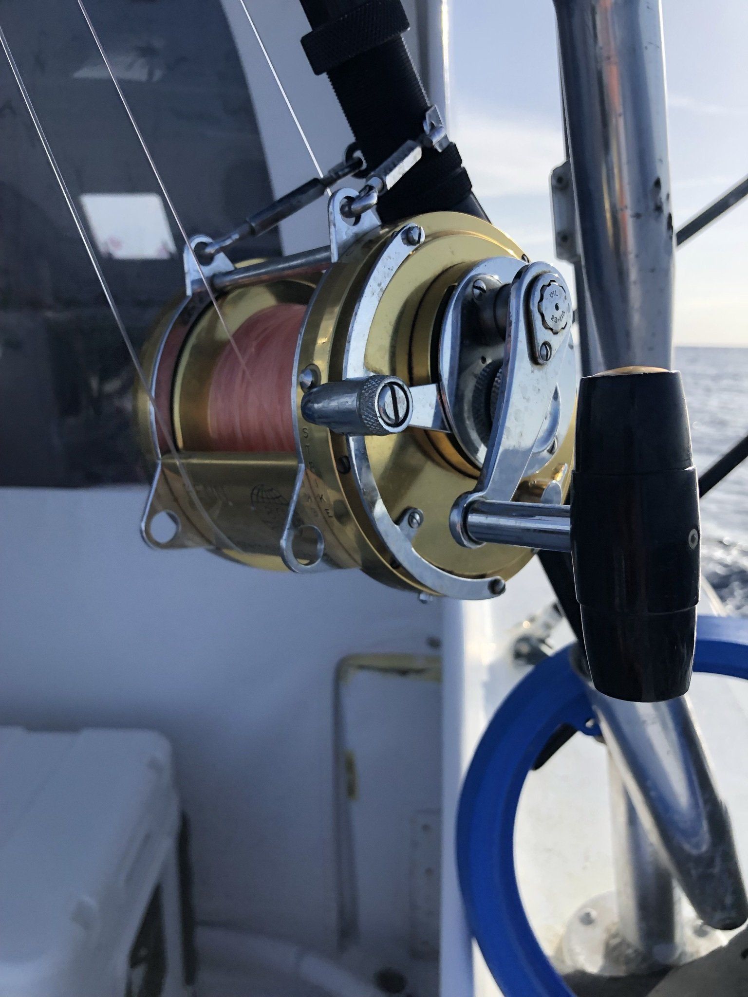 A close up of a fishing reel on a boat