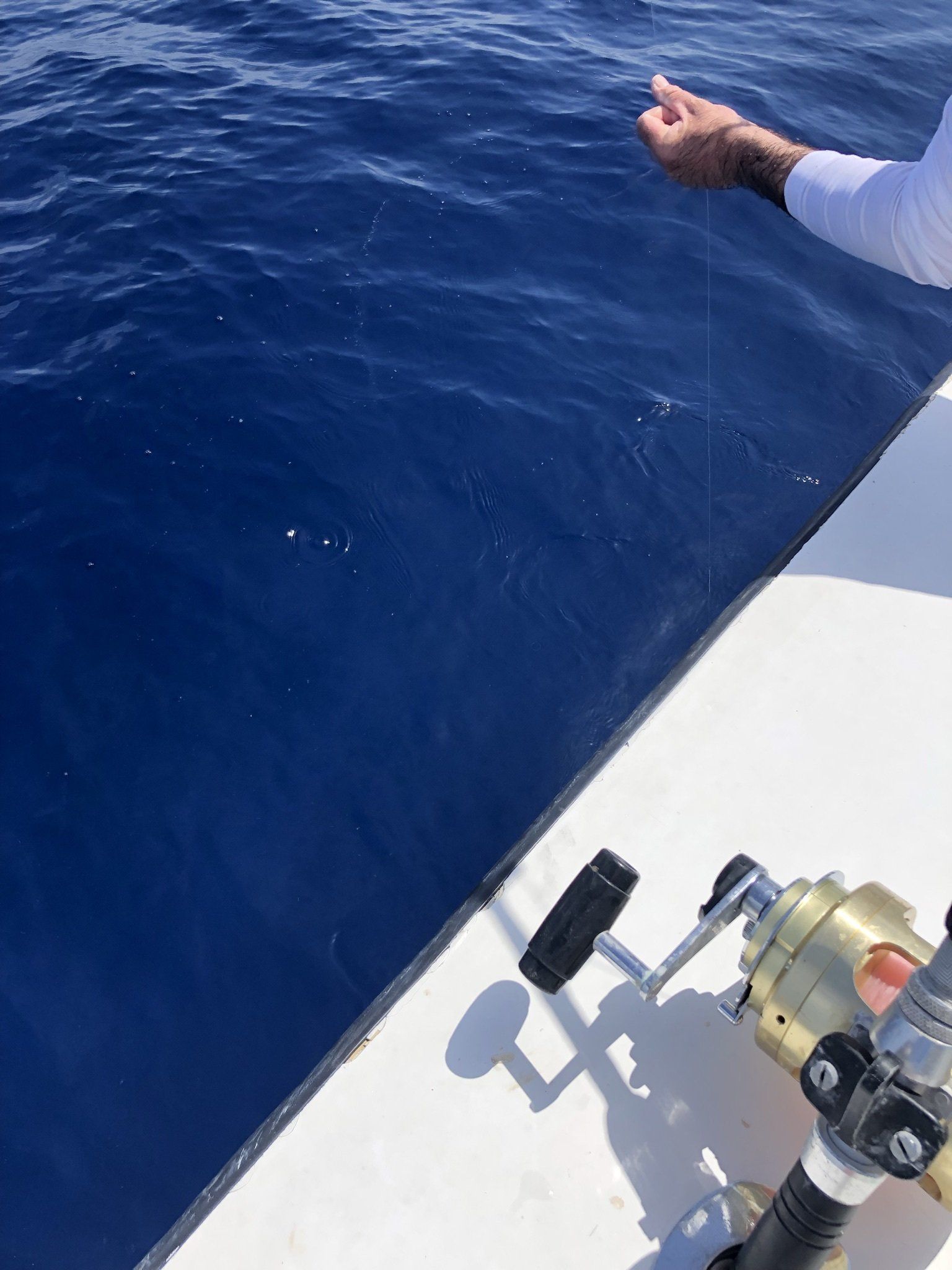 A person is fishing in the ocean with a fishing rod.