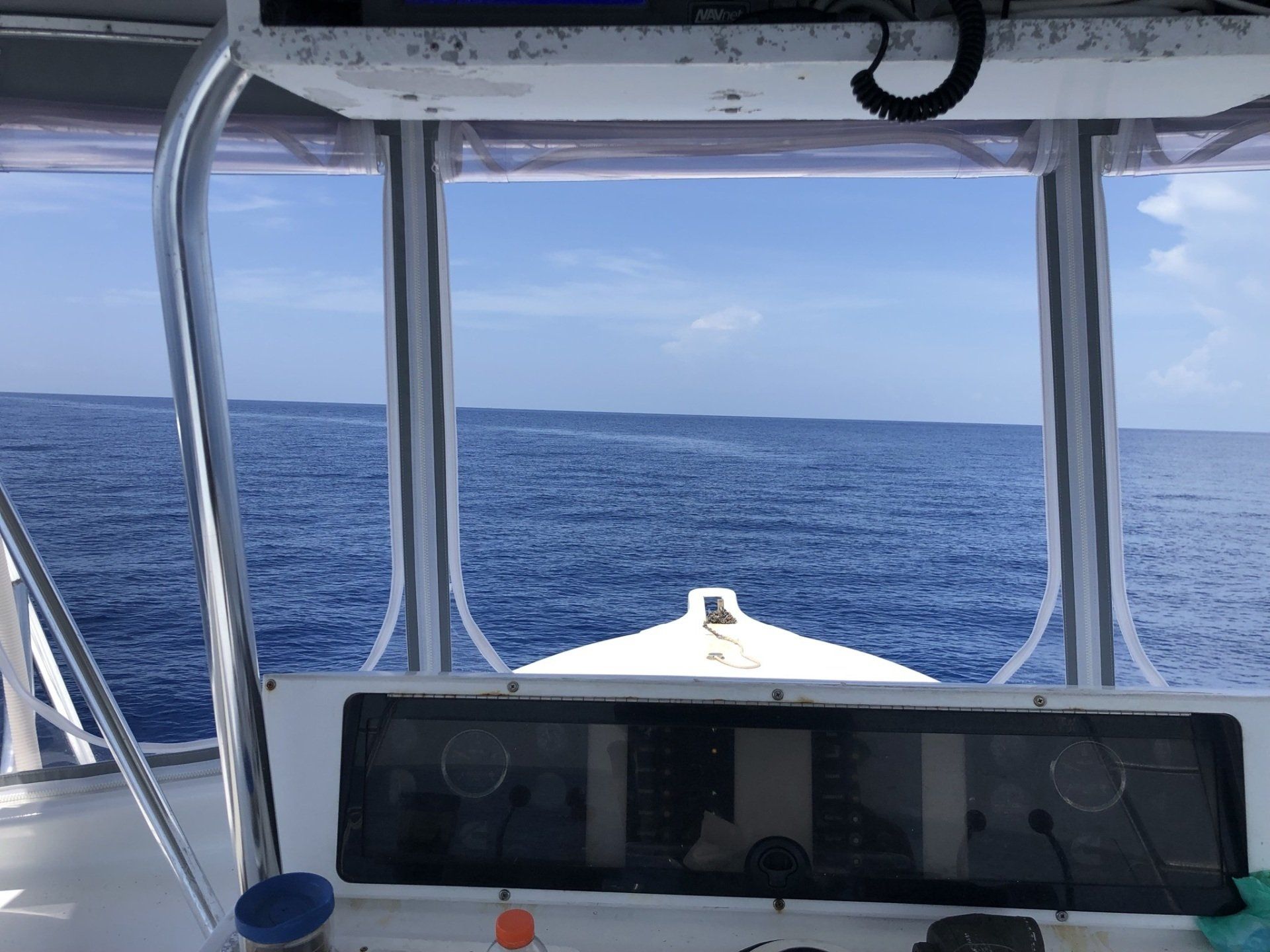A view of the ocean from the cockpit of a boat