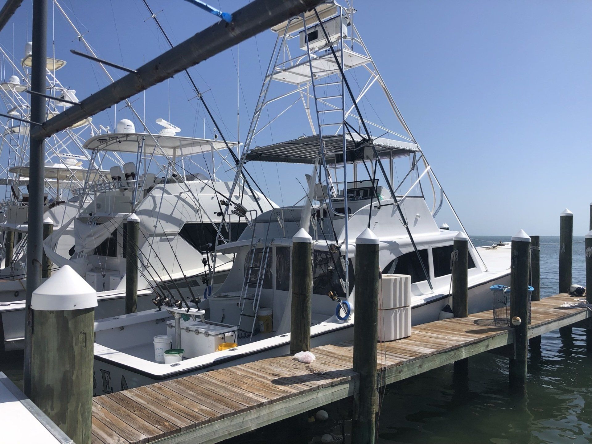 A group of boats are docked at a dock in the water.