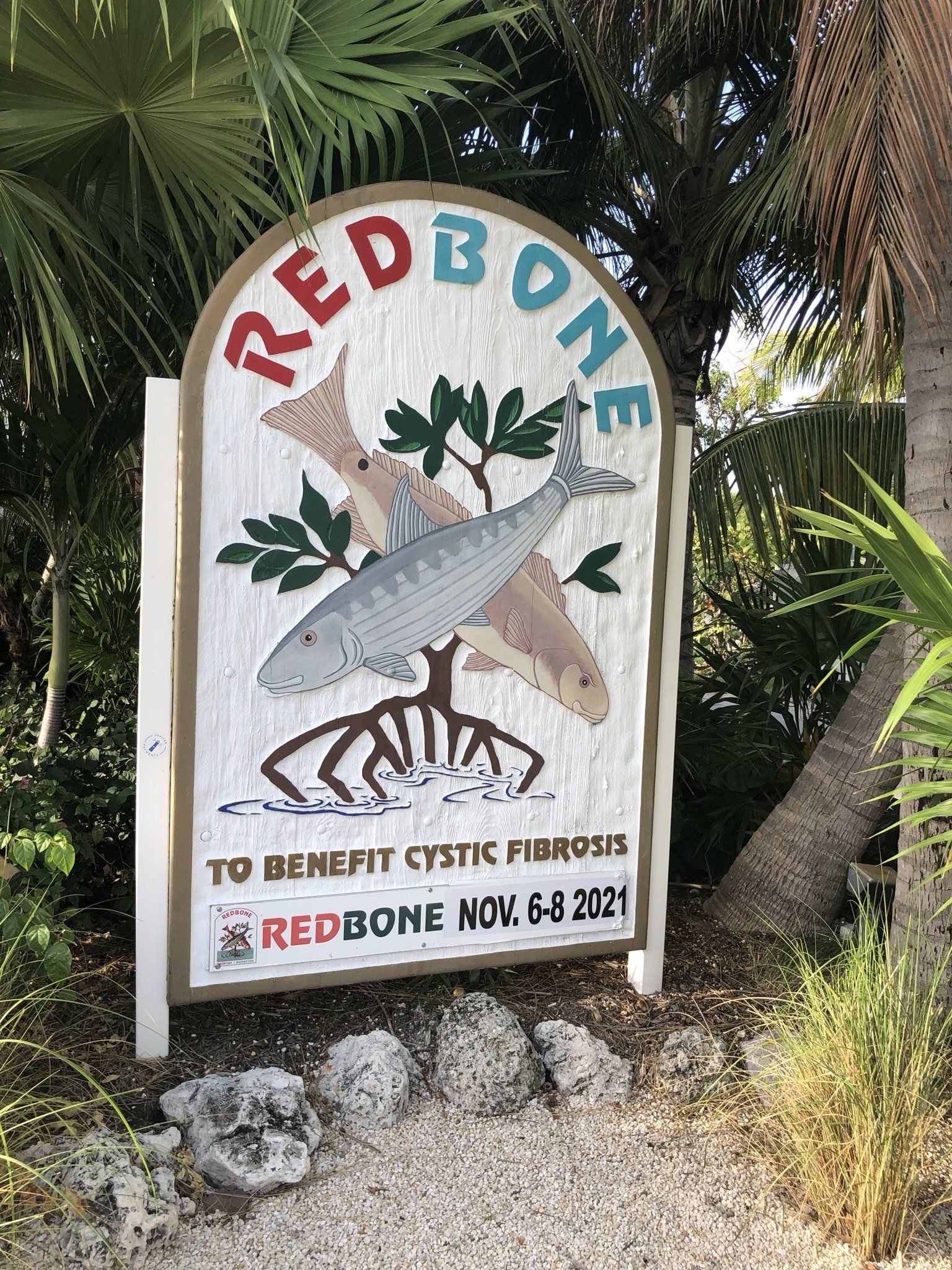 A sign that says `` redbone '' with a picture of fish on it.