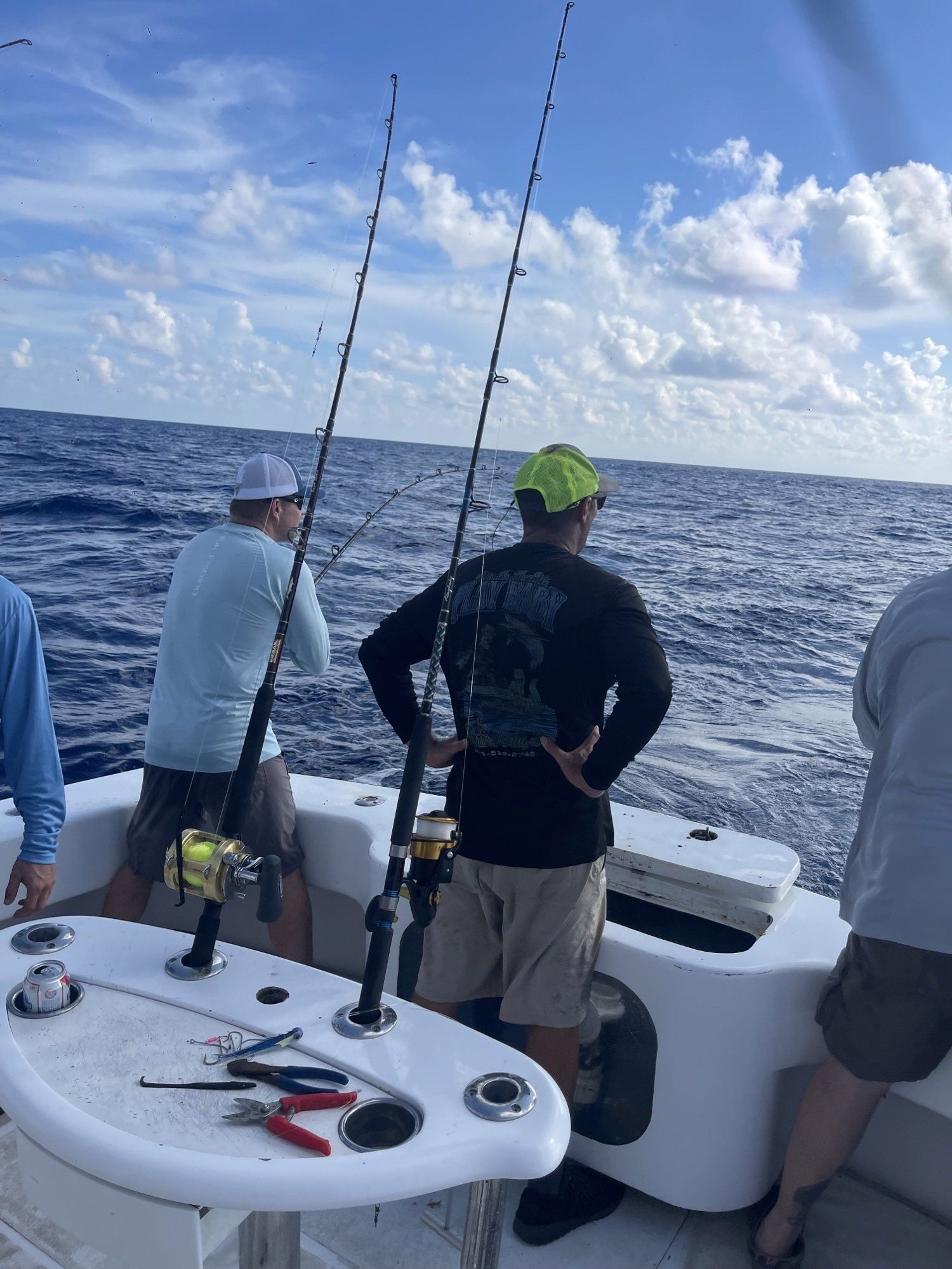 A group of men are fishing on a boat in the ocean