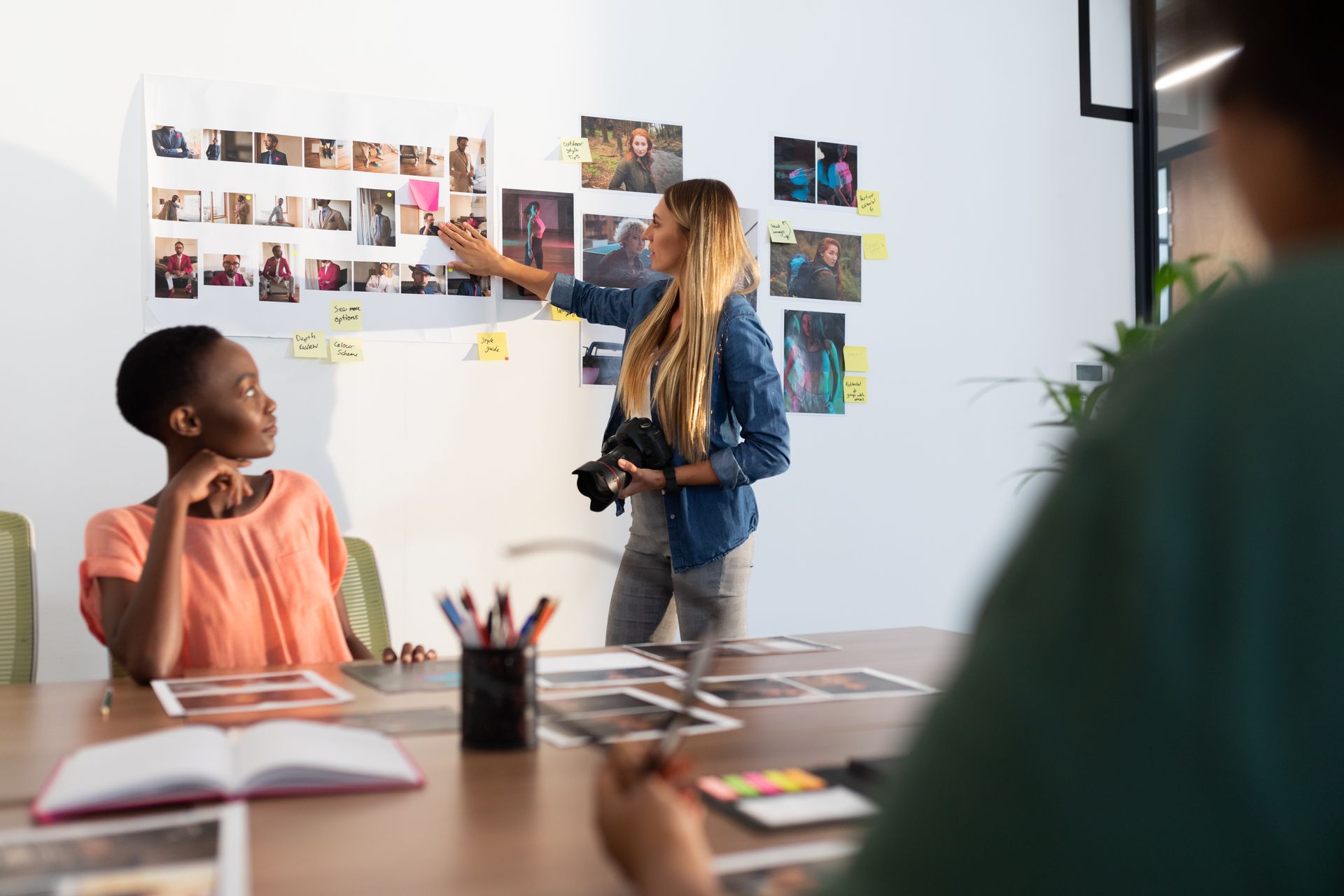 A woman is giving a presentation to a group of people in a conference room.