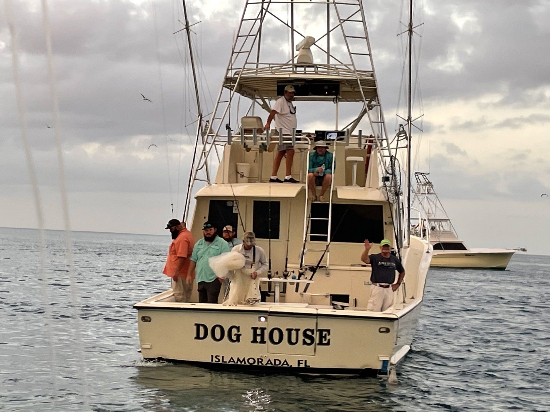 A boat with the name dog house on the back