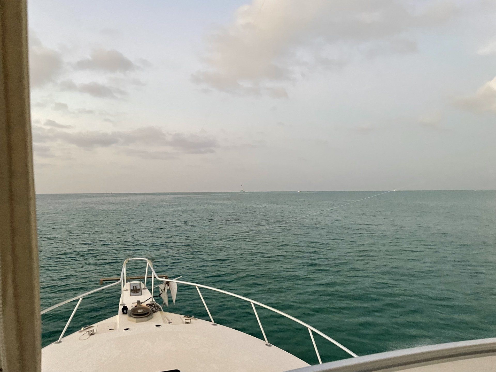 A boat is floating on top of a large body of water.