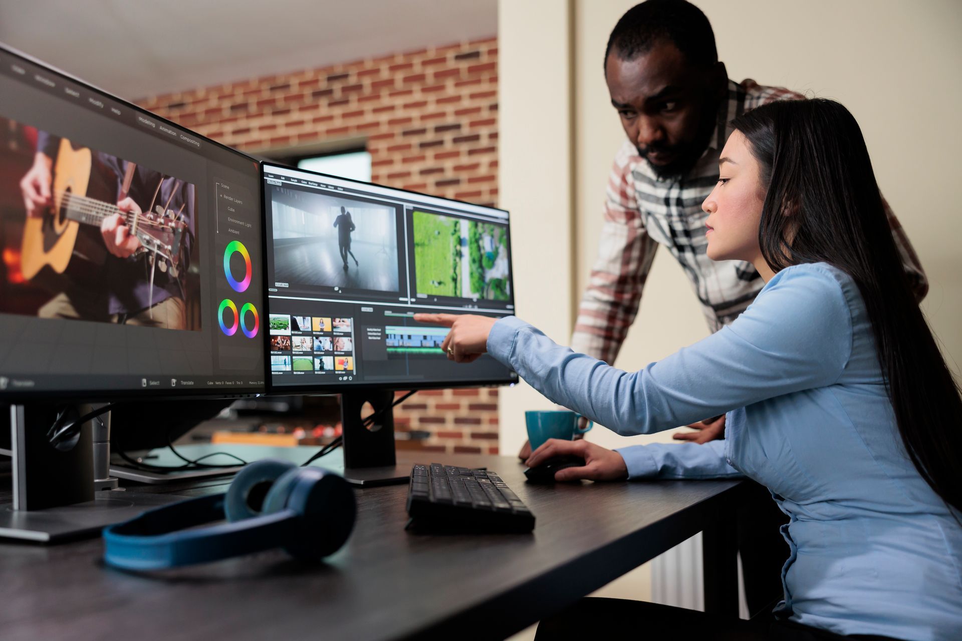 A man and a woman are looking at a computer screen.