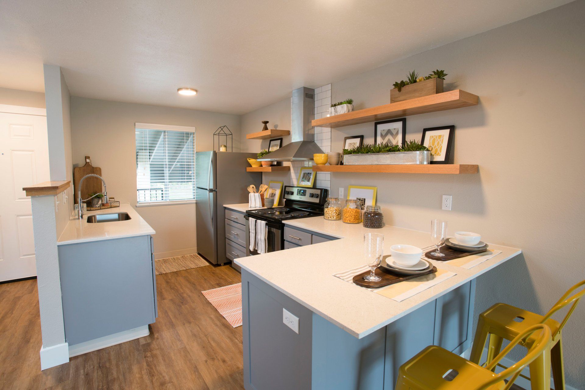 Alternate Interior of kitchen furnished with white countertops and stainless steel appliances