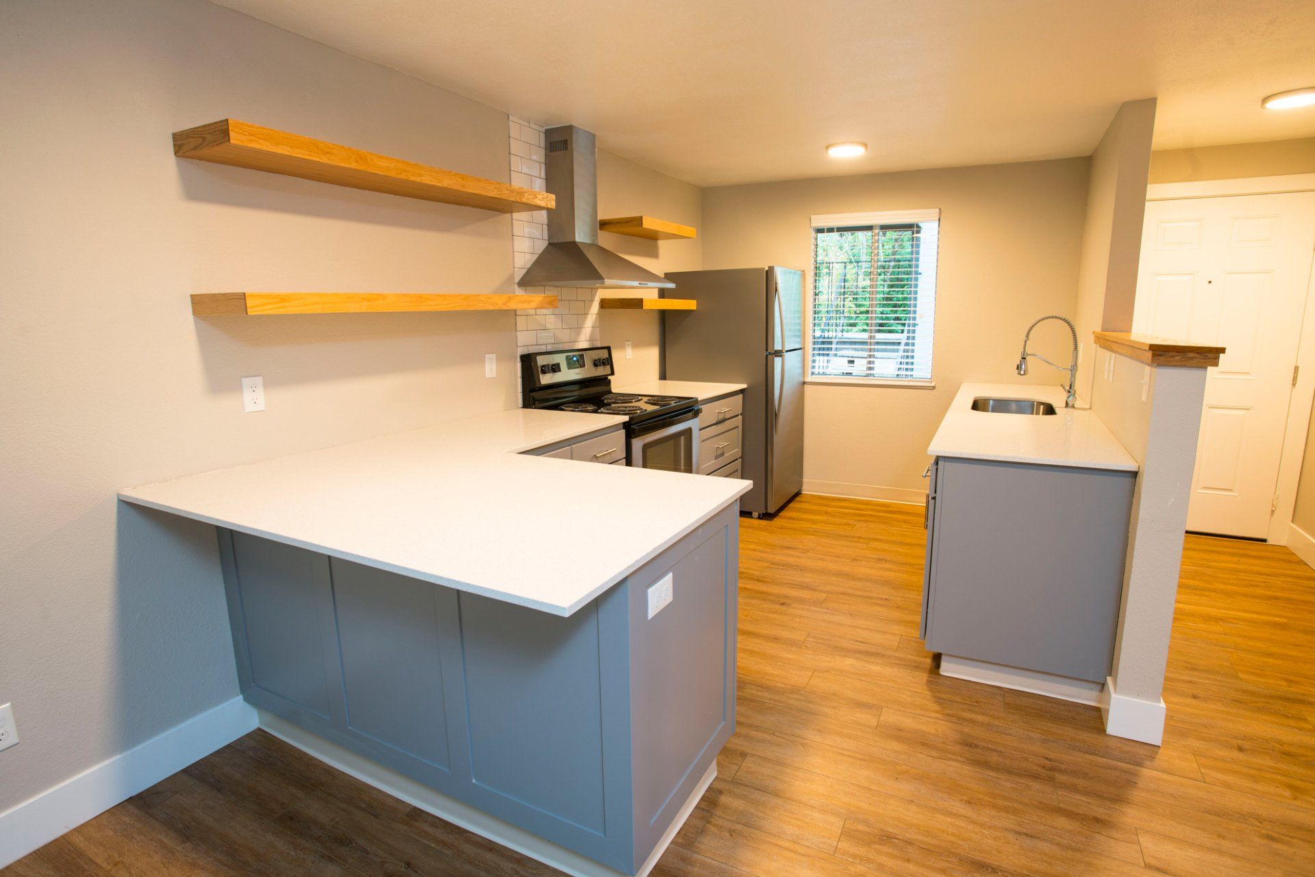 Alternate Interior of kitchen with stainless steel appliances and wood flooring