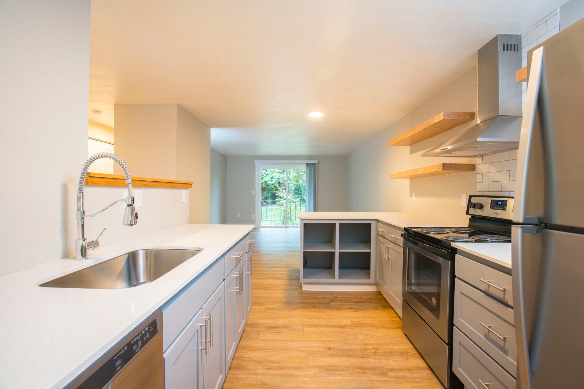 Interior of kitchen with stainless steel appliances and wood flooring