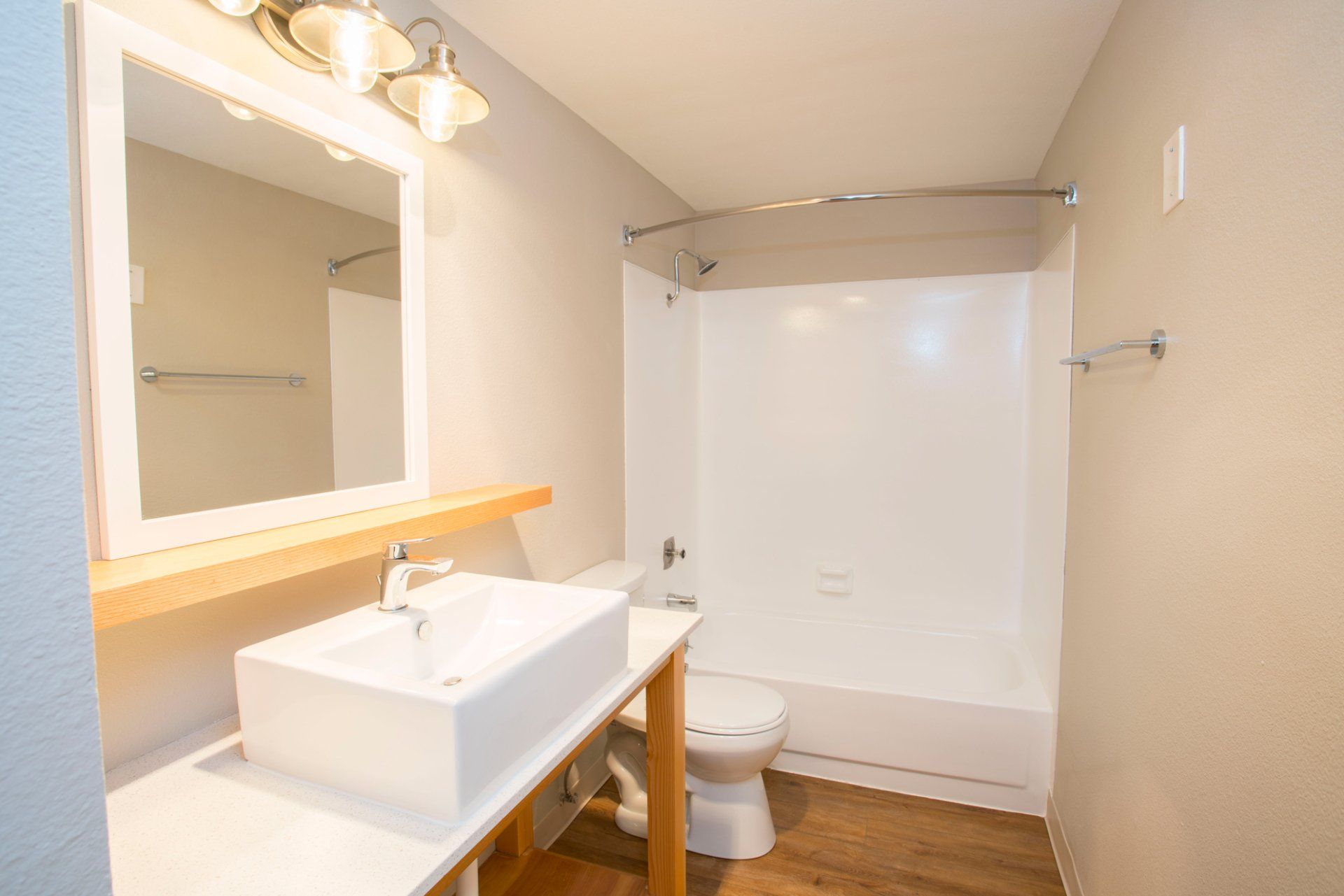Interior of bathroom with white sink and wood accents