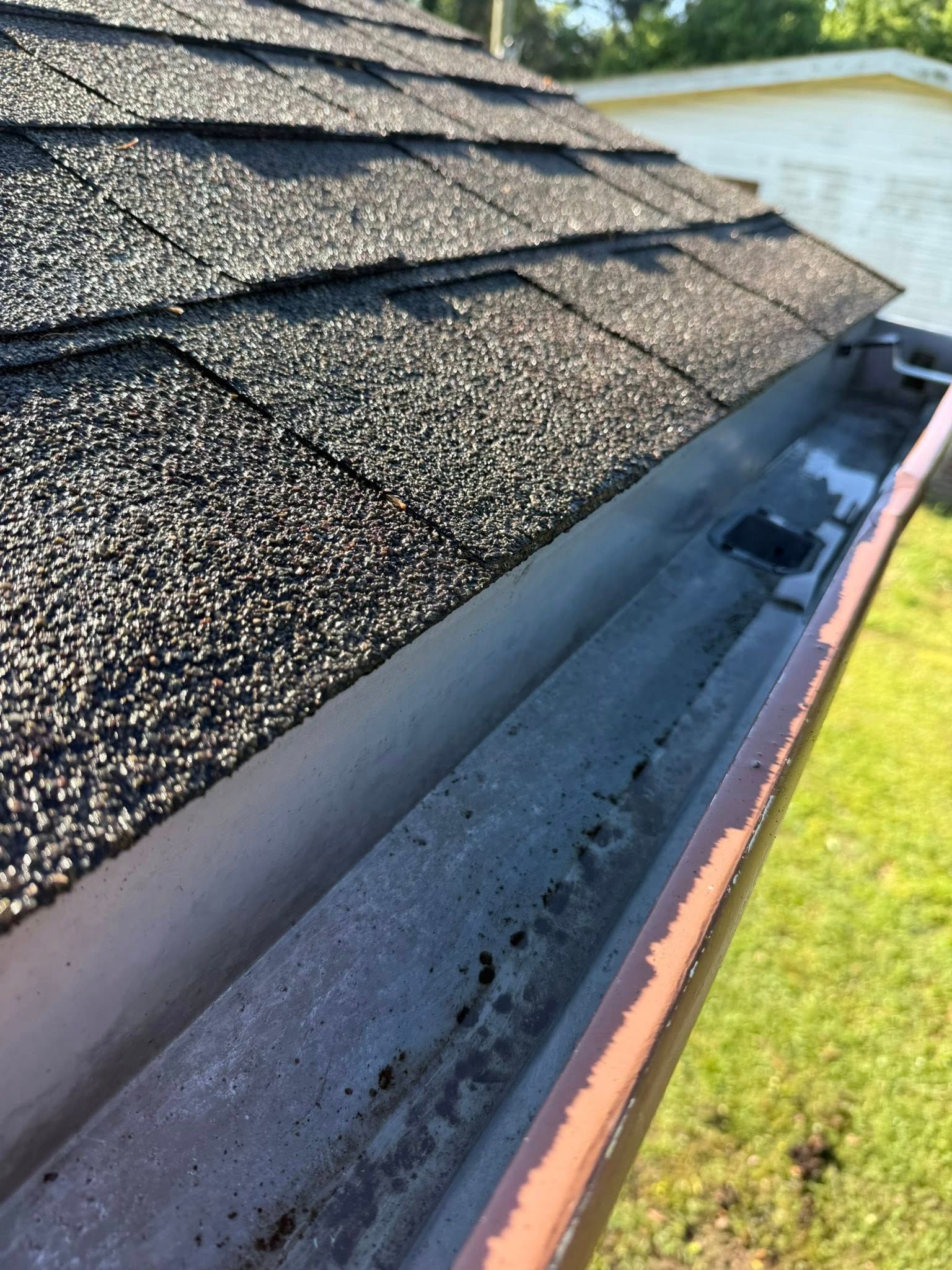 A close up of a gutter on top of a roof.