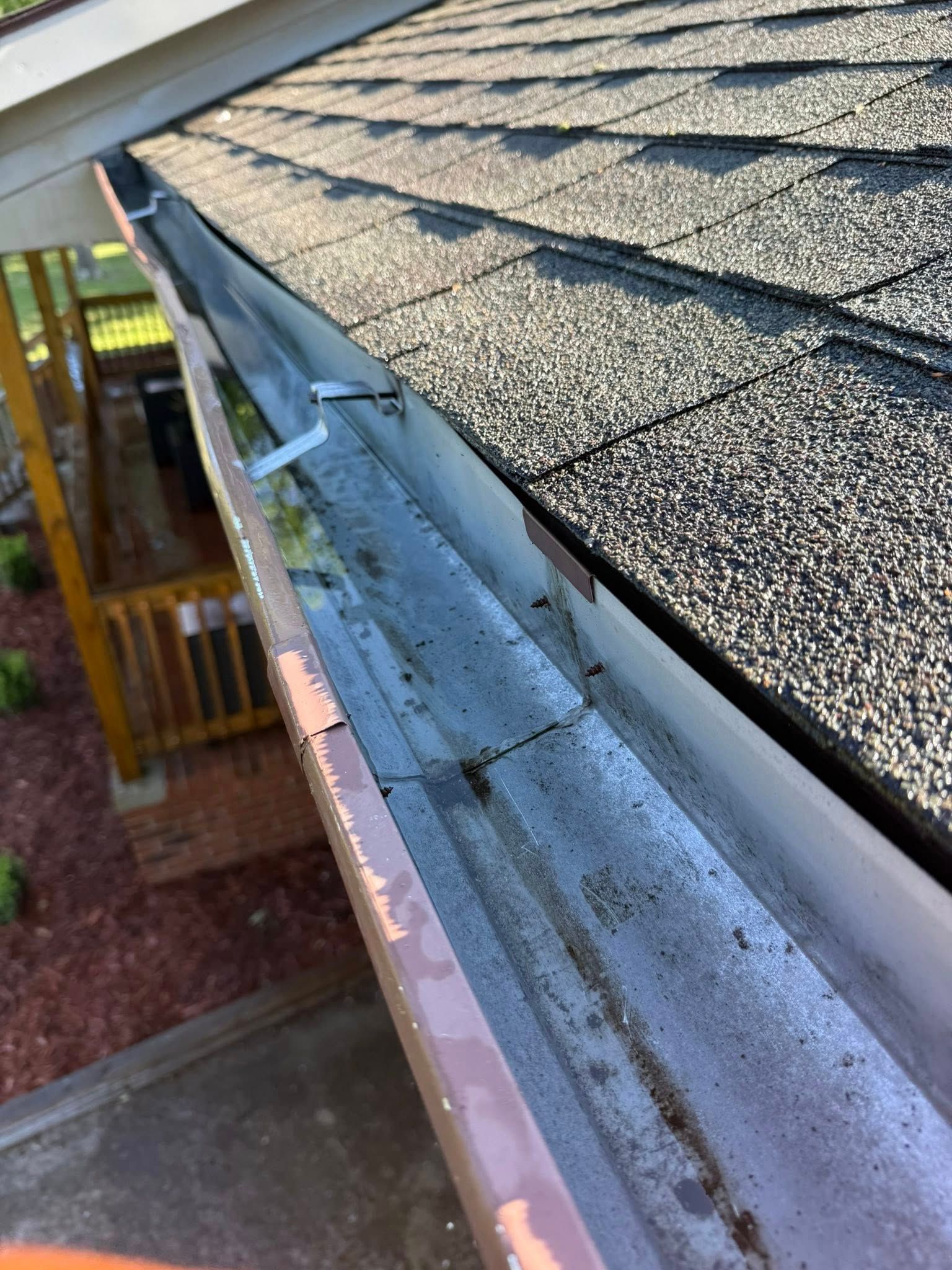 A close up of a gutter on a roof of a house.