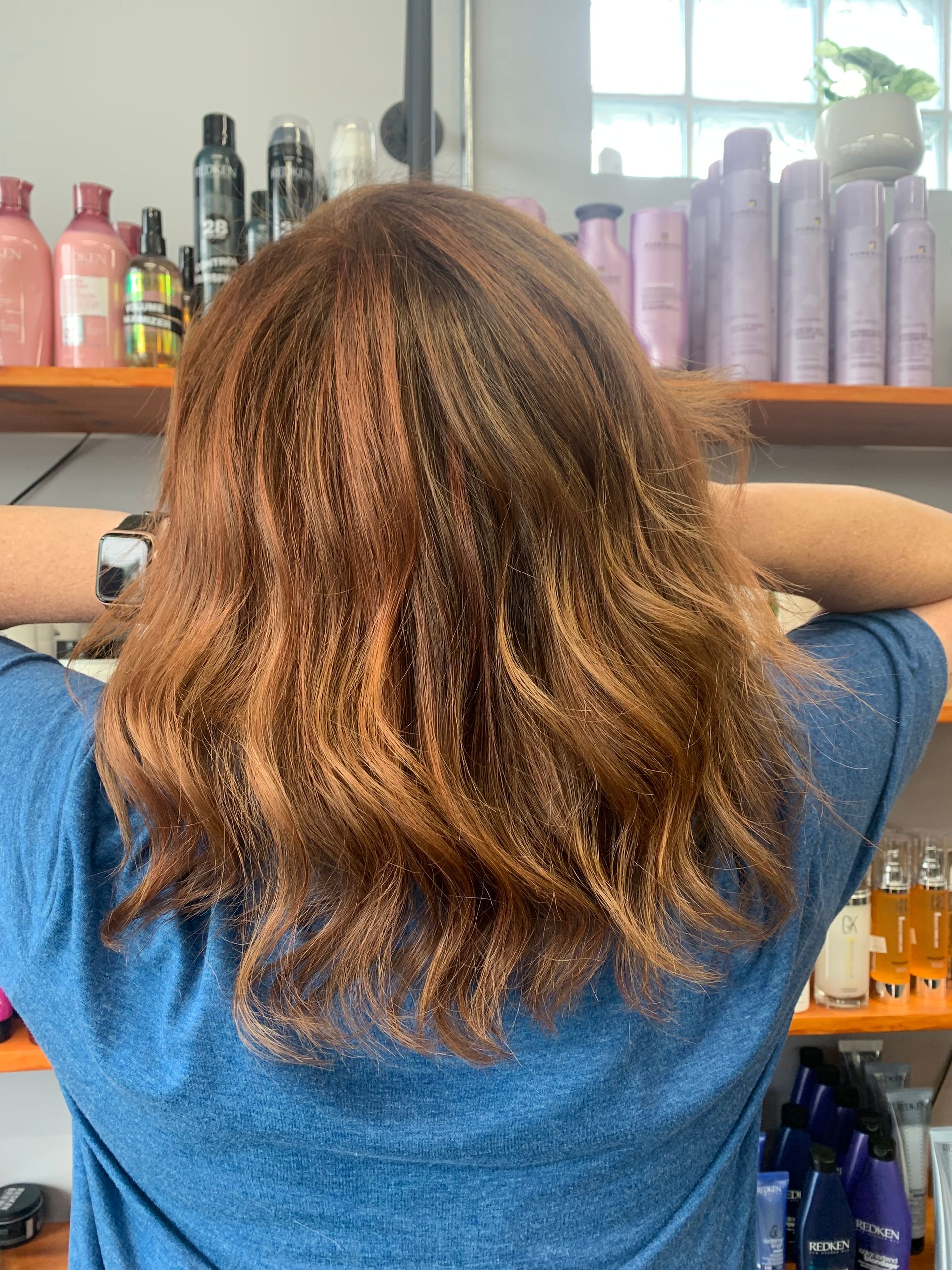 Before-and-after photos of hair colored from a light orange-ginger to a vibrant, deep red.