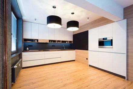 Black and White kitchen with wood flooring