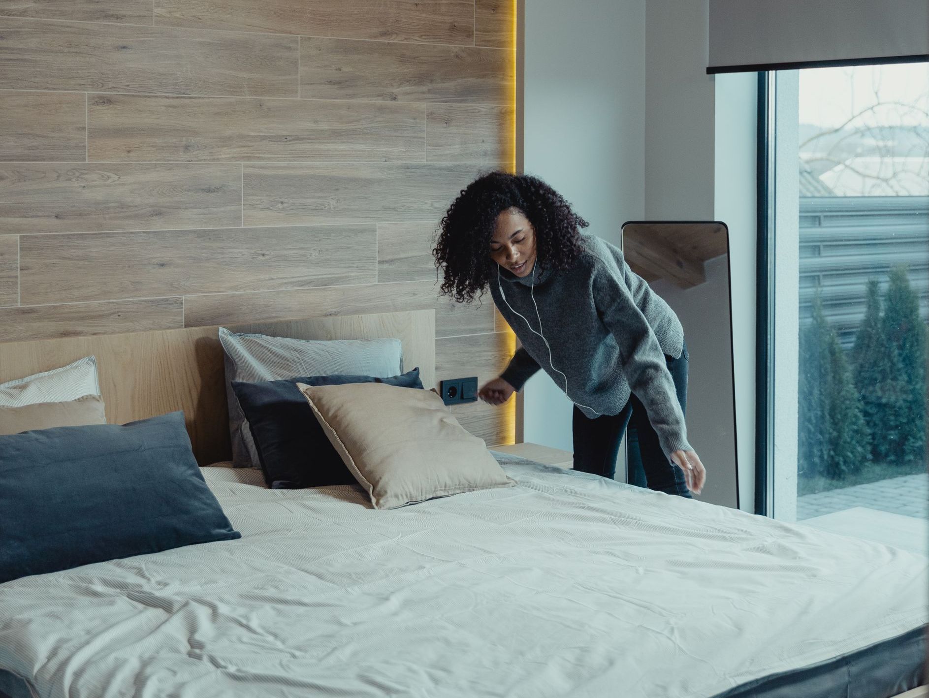 Woman fixing the bed